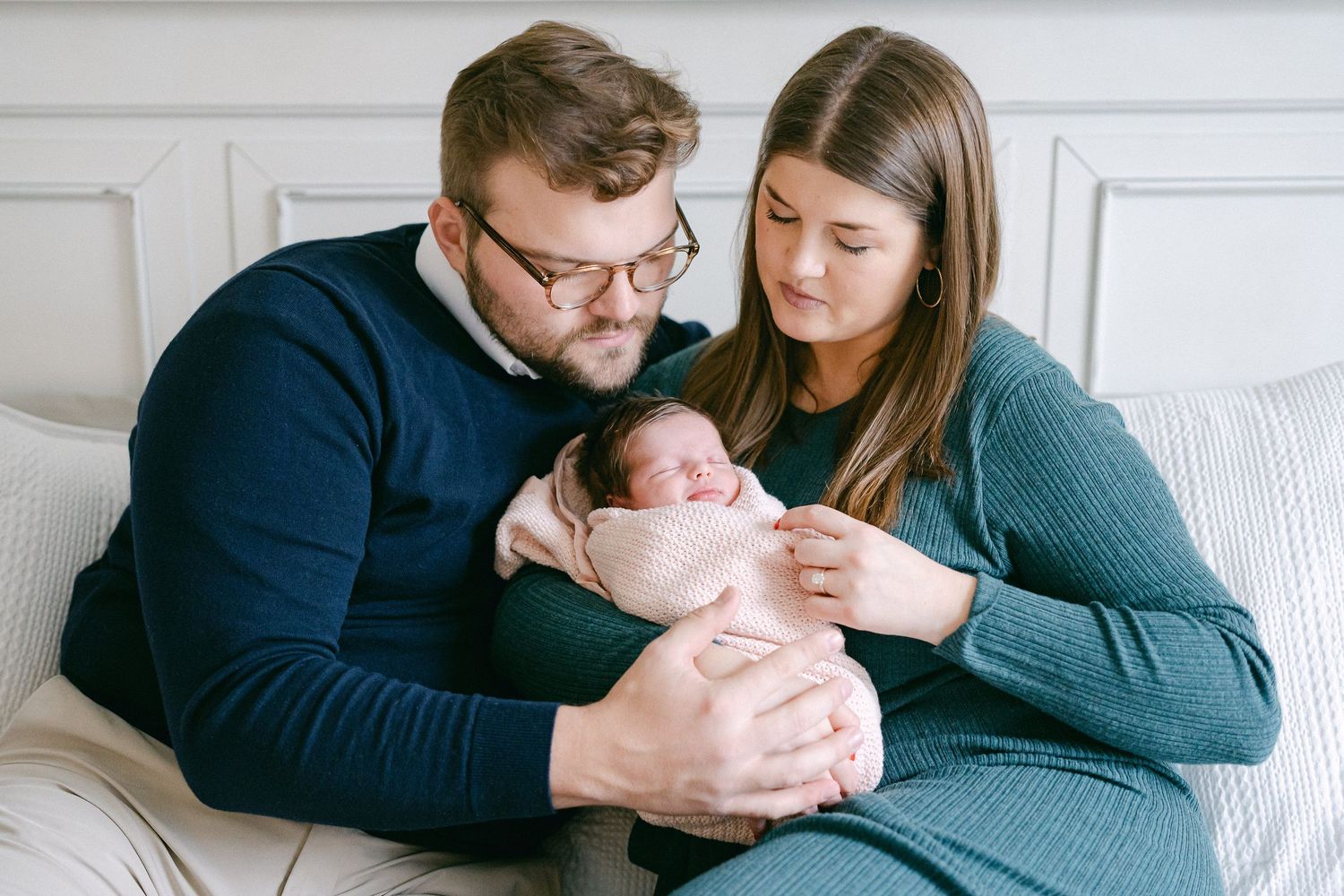 A series of tender family moments with a newborn baby photographed in a light-filled room.