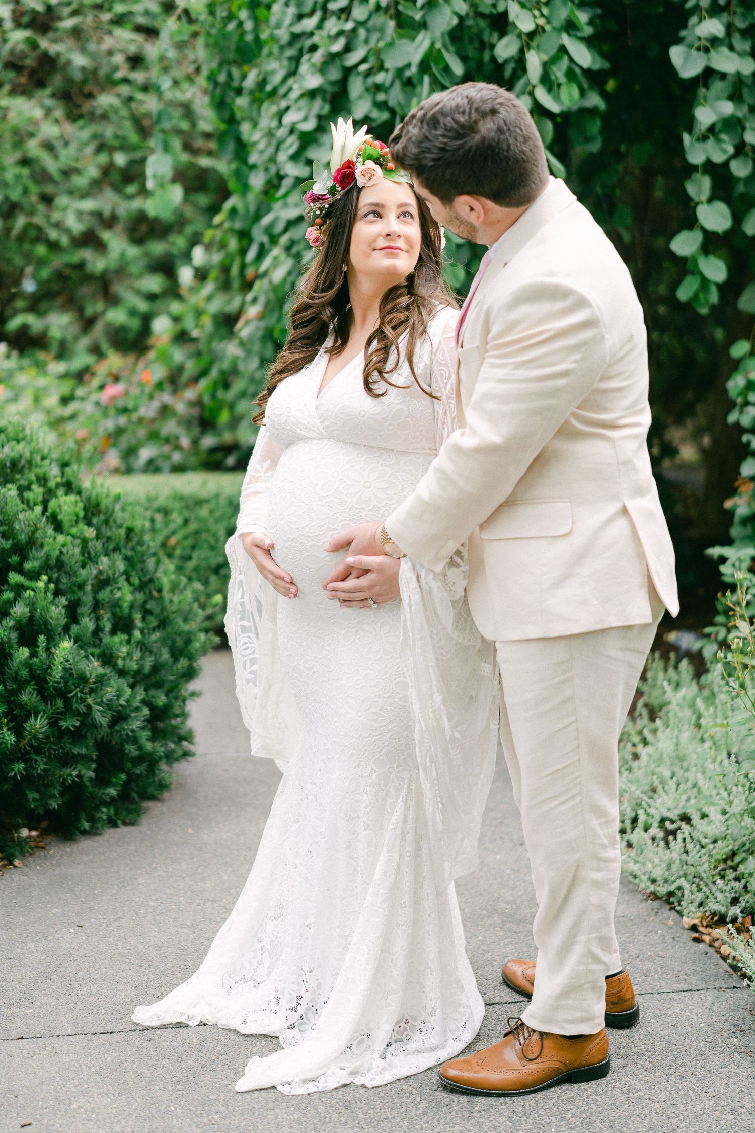 A romantic outdoor wedding moment captured in a series of intimate poses against lush greenery and garden foliage.