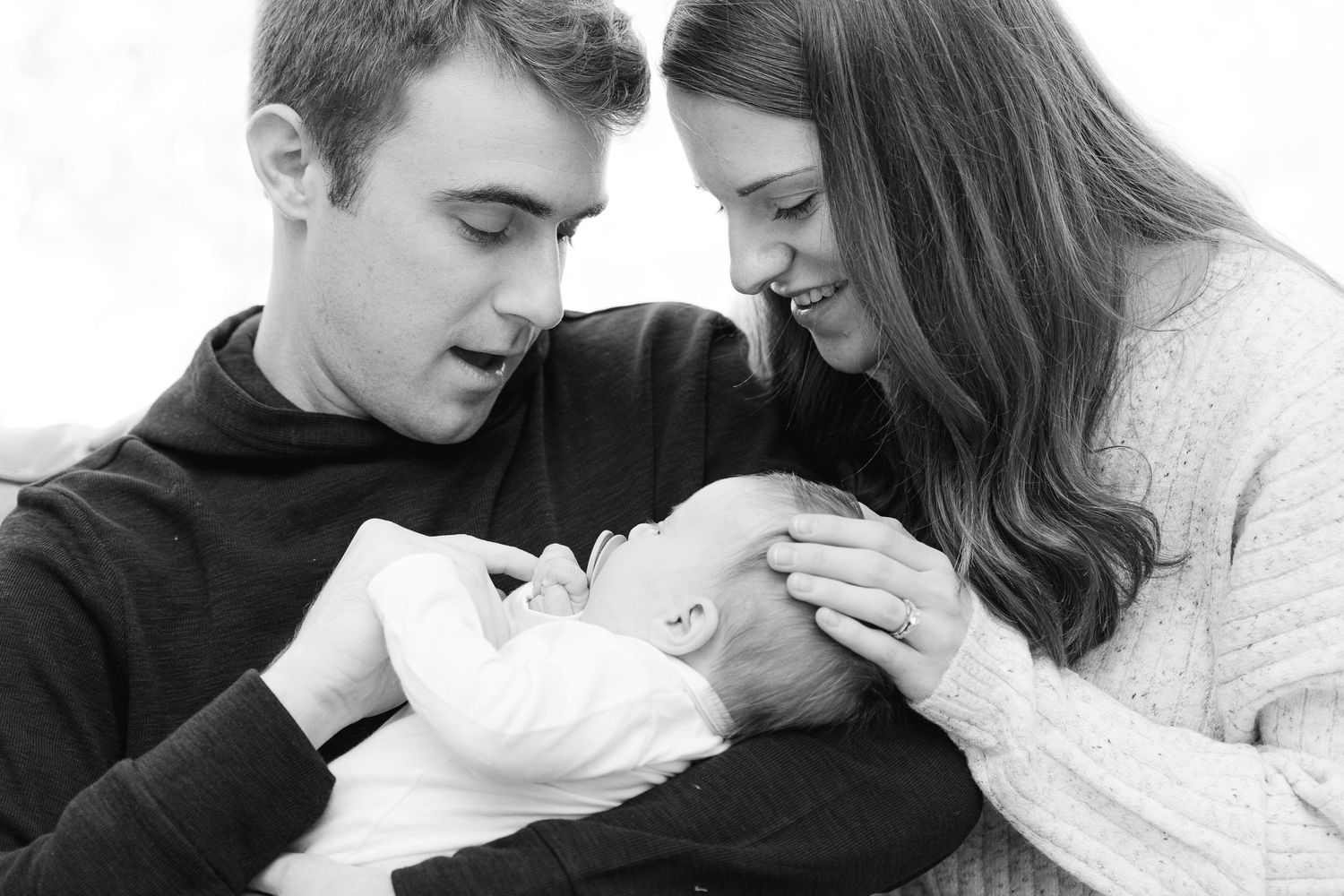 A romantic black and white photo series showing tender moments between a couple in intimate poses.