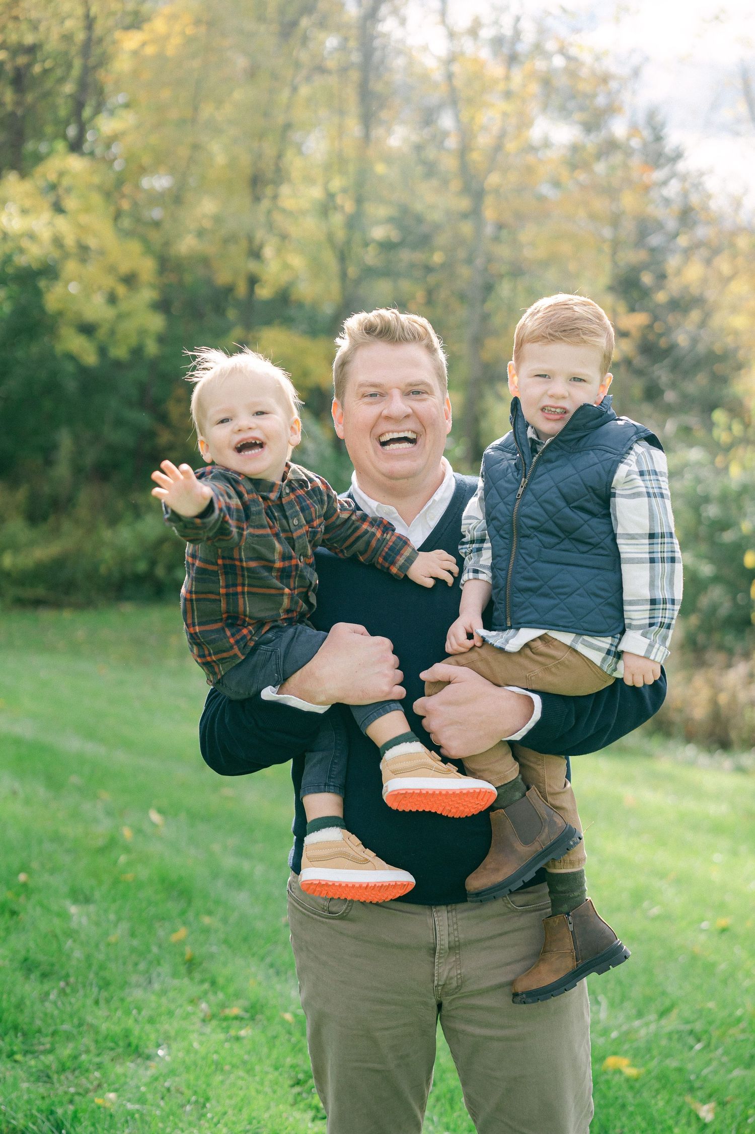 Candid family photos show playful interactions in a sunny autumn field with coordinated casual outfits.