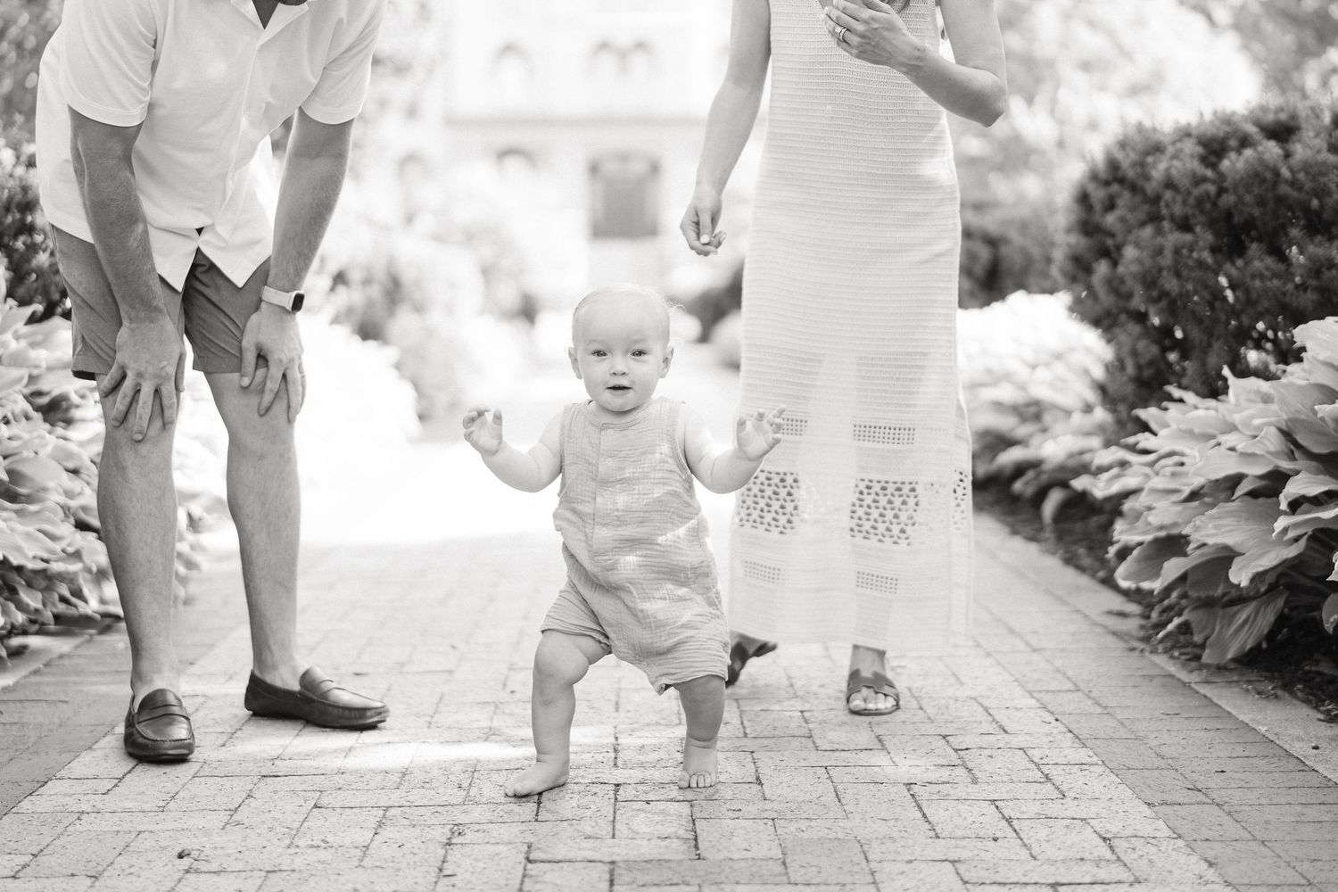 Black and white photo series showing small feet walking on a stone path in a garden setting.