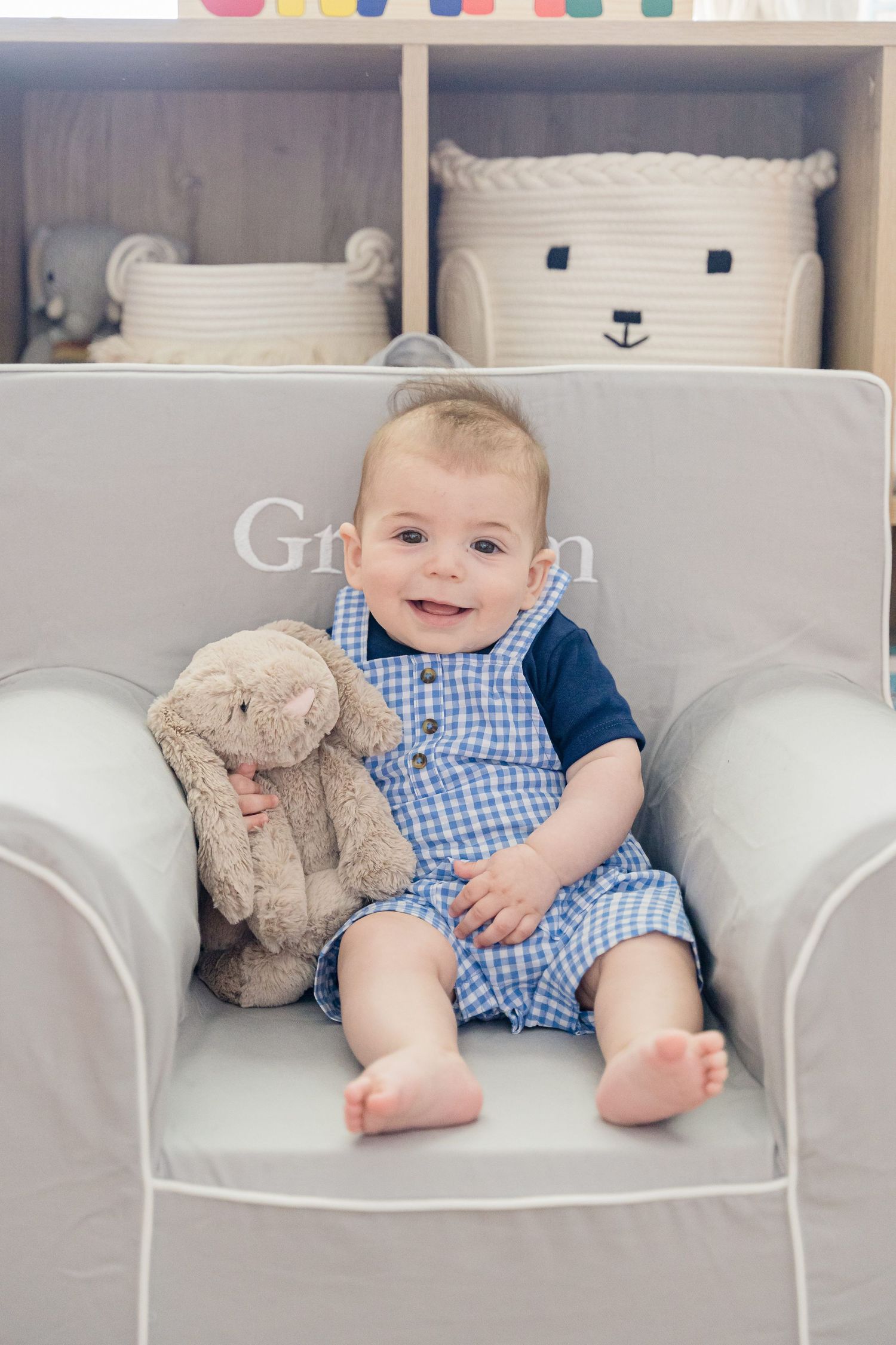 Baby in blue gingham outfit sits on white couch with plush bunny toy in series of sweet candid moments.