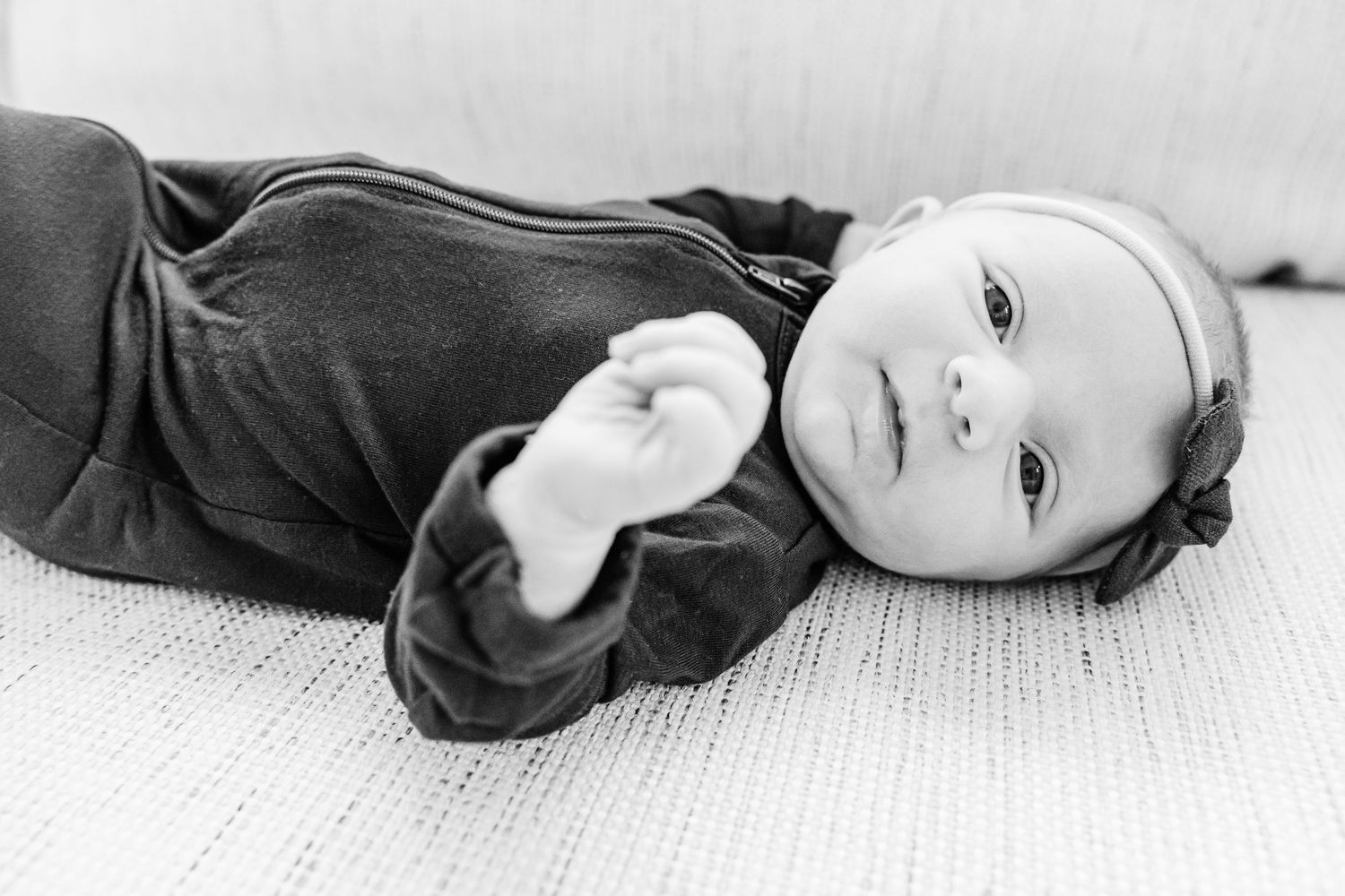 A series of black and white artistic portrait photographs showing reclining poses against a white background.