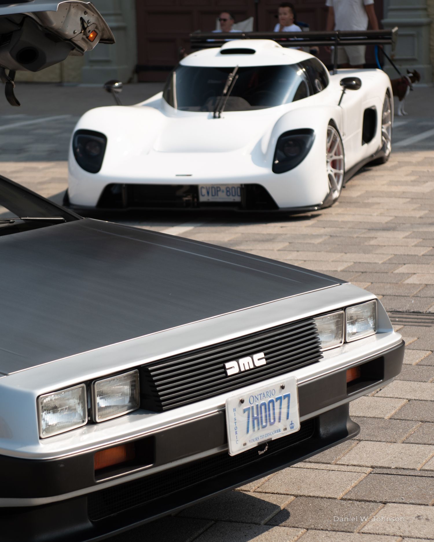 Close-up detail shots of a classic DeLorean DMC-12's stainless steel body and distinctive grill design.