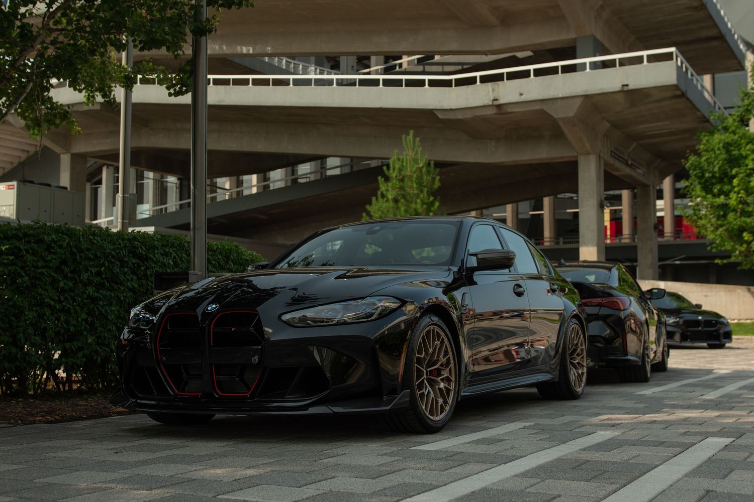 Parked luxury vehicles in an outdoor parking garage