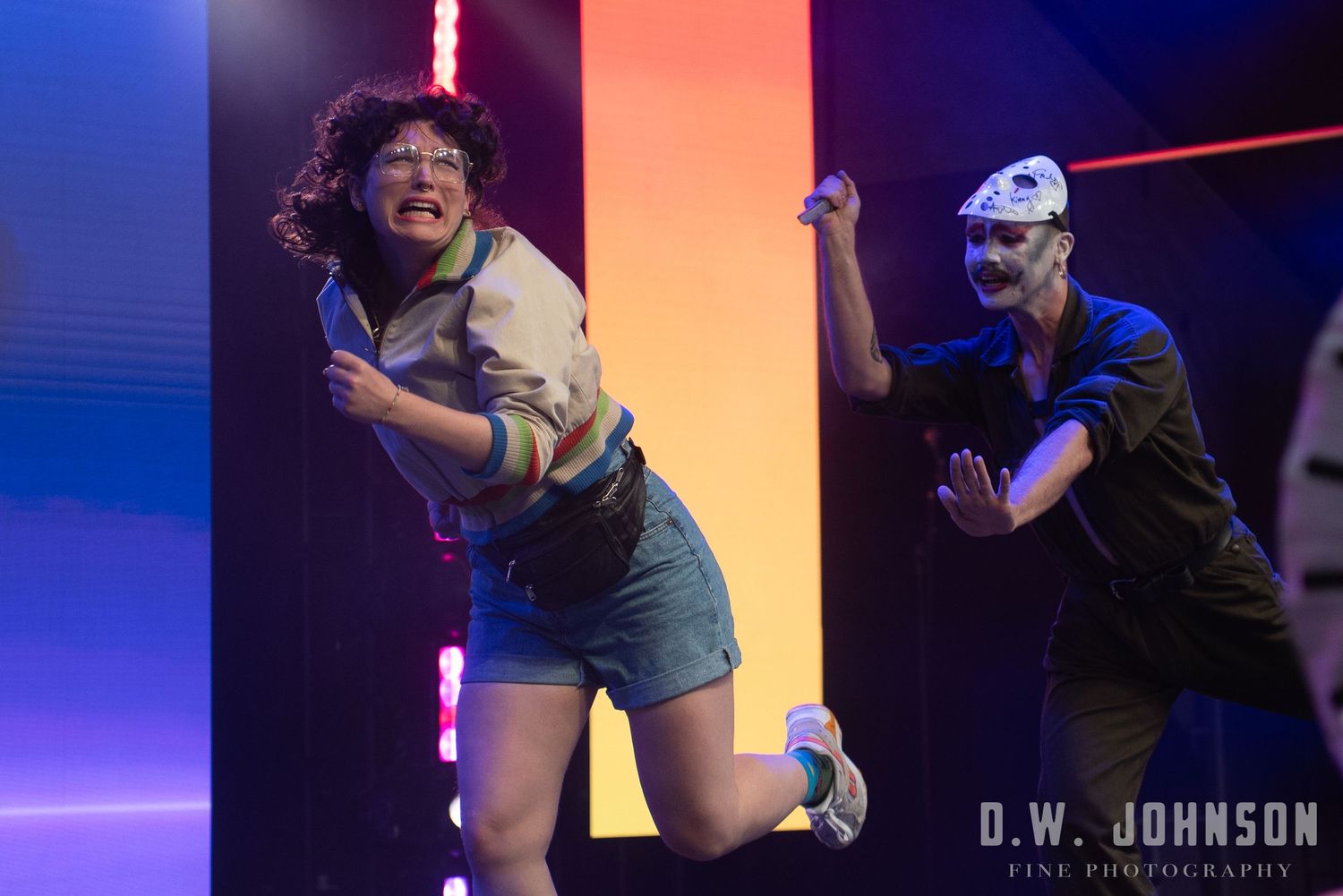 Dramatic stage performance with colorful lighting effects and dynamic movement captured in sequence.