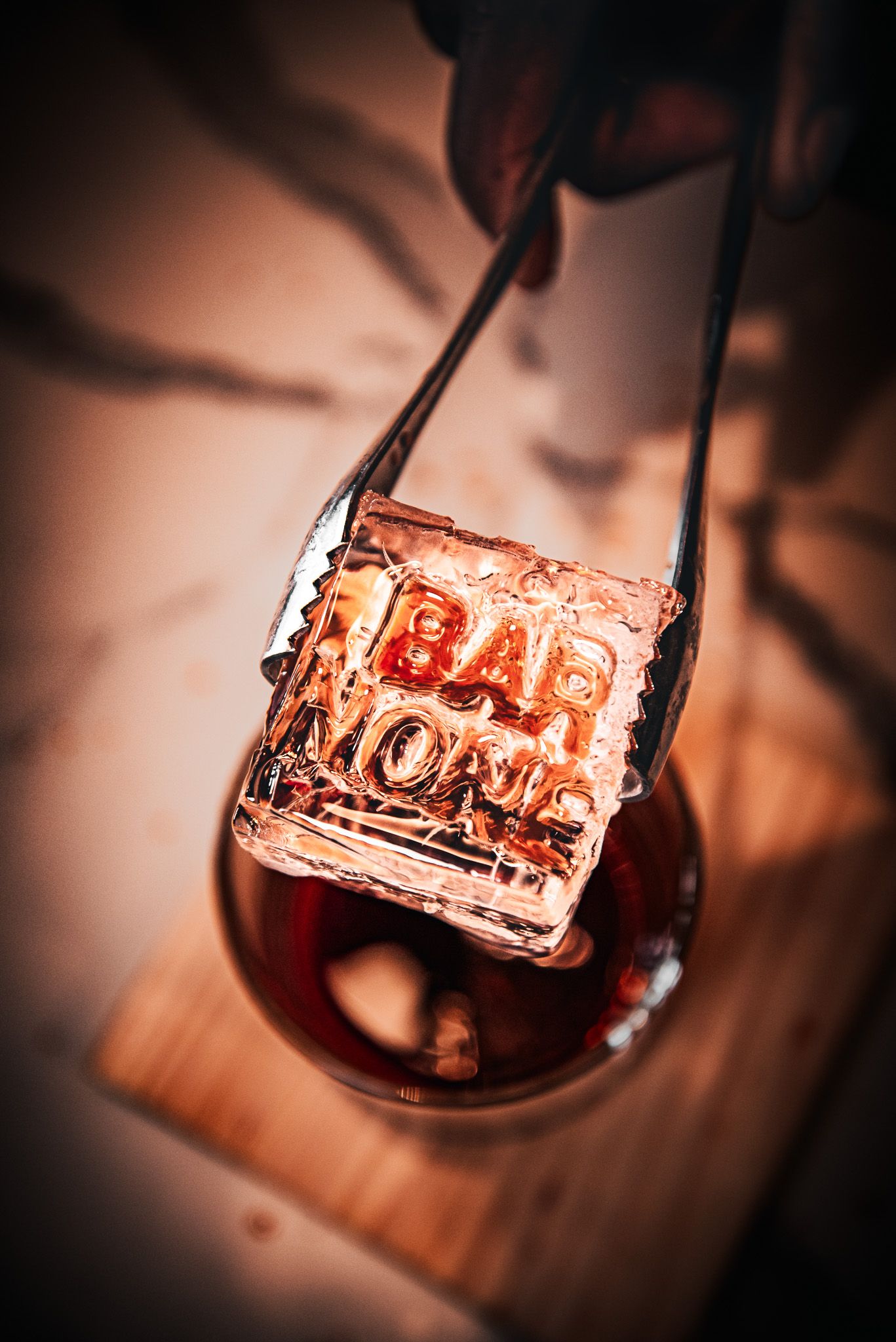 Macro shots of red wine being poured into a glass with dramatic lighting and dark background creating a rich ambiance.
