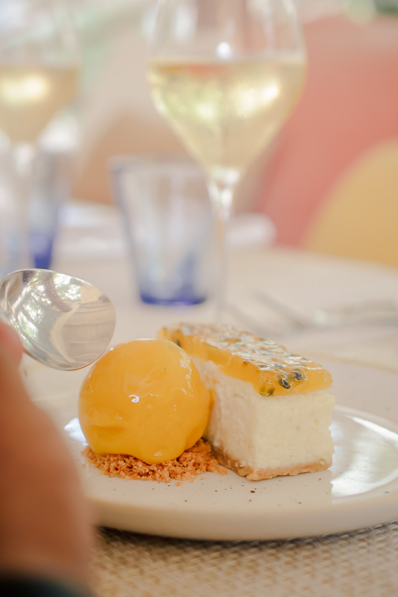 Artfully presented dessert plates featuring citrus spheres and creamy elements on pristine white dinnerware.