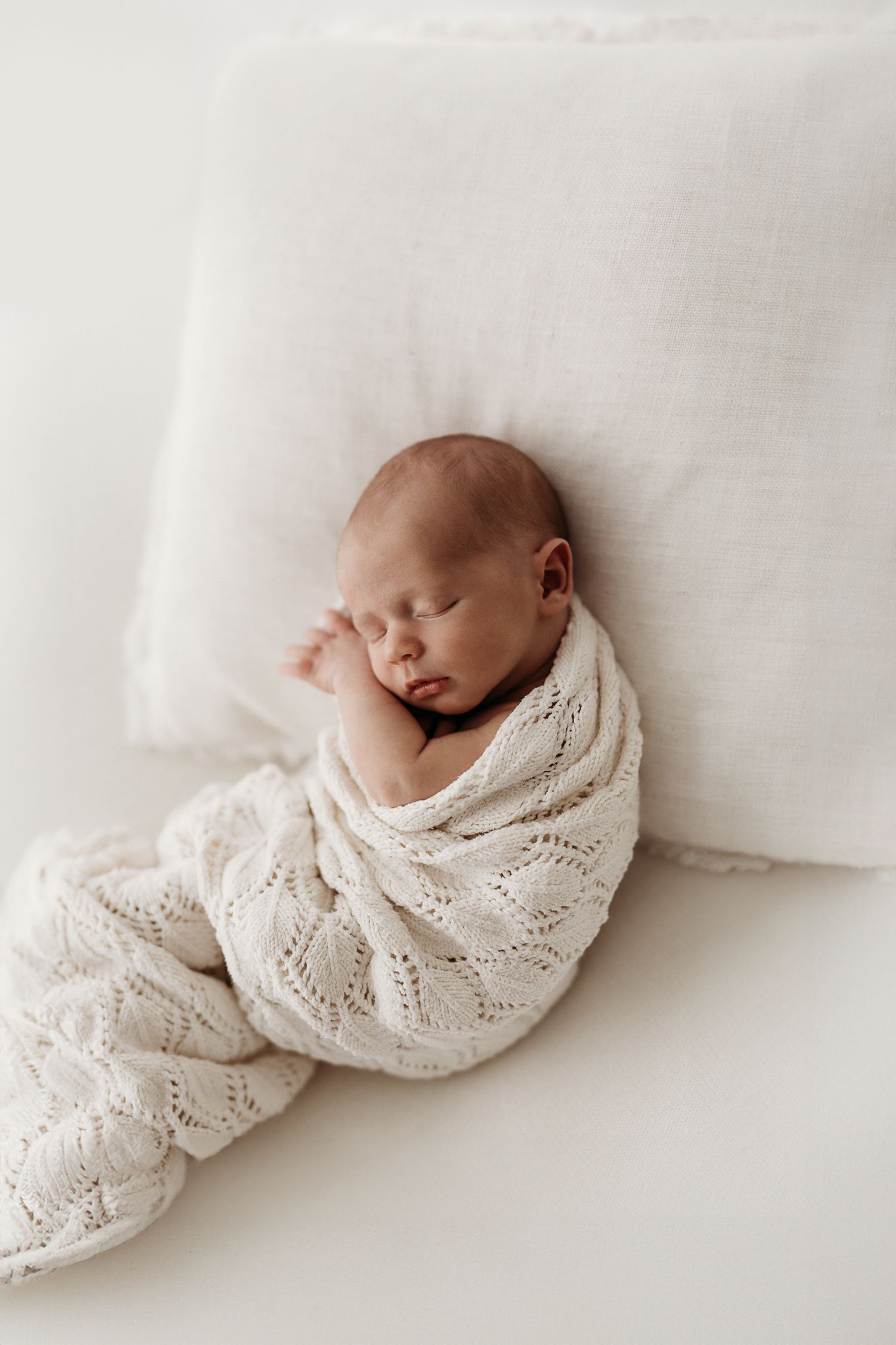 Sleeping newborn photographed in neutral tones by Sunshine Coast baby photographer