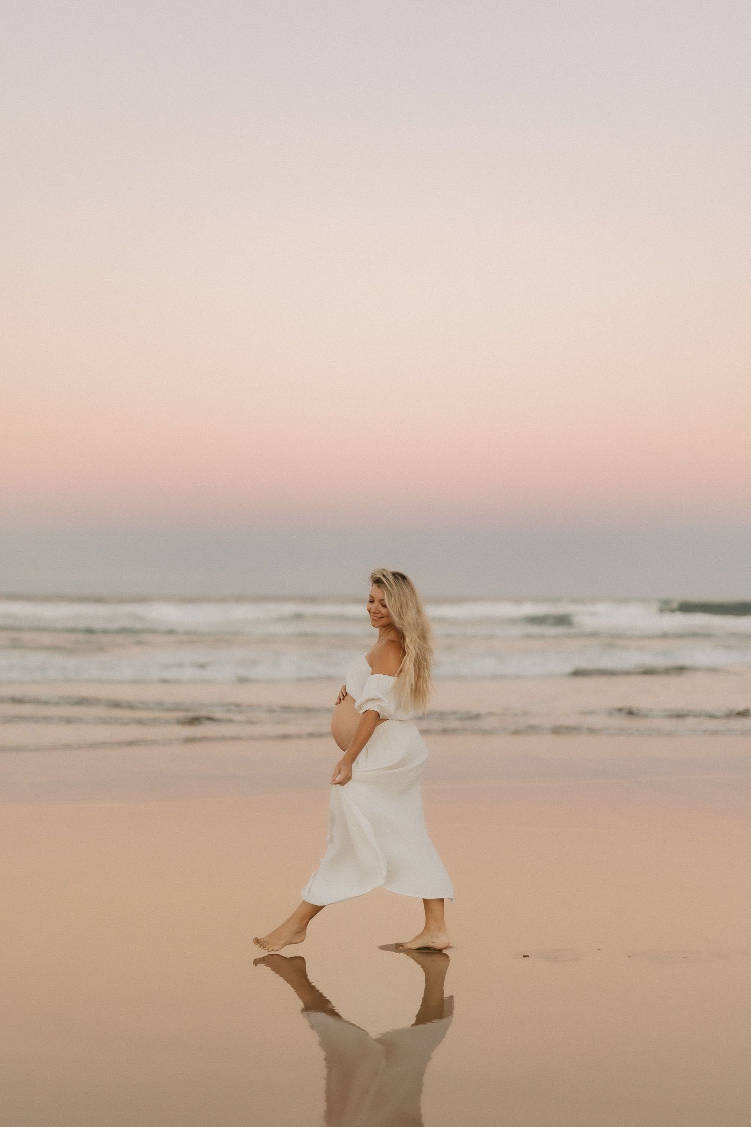 Pregnant mum walking along beach during Sunshine Coast maternity photography session