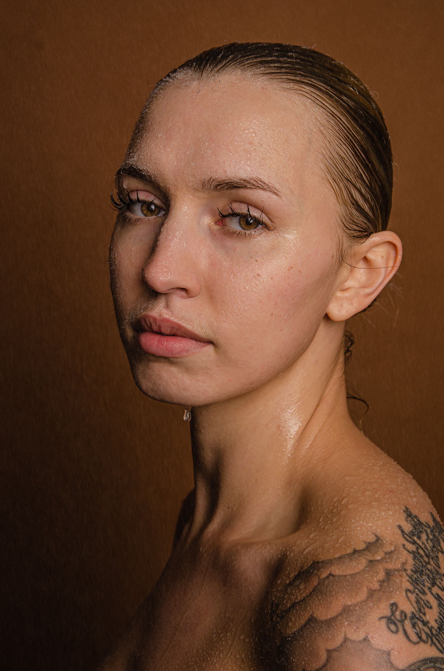 a editorial photoshoot of a girl dripping with water.