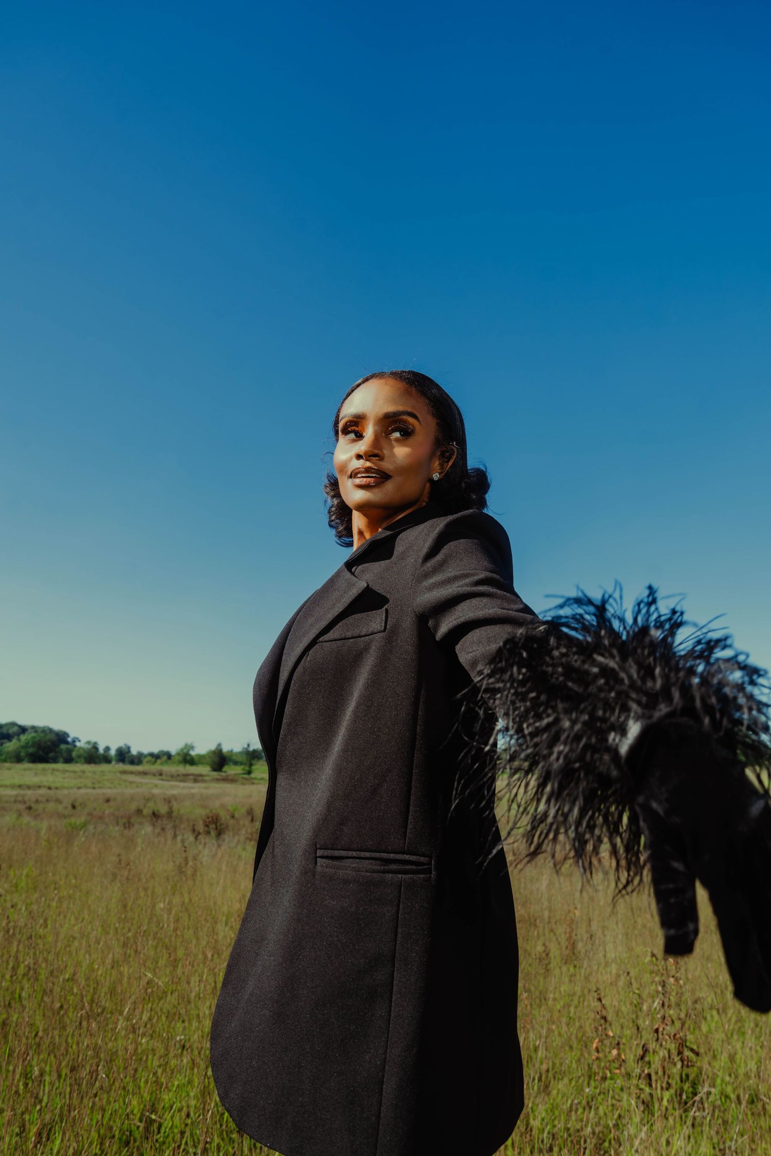 Girl in tall grass posing-editorial