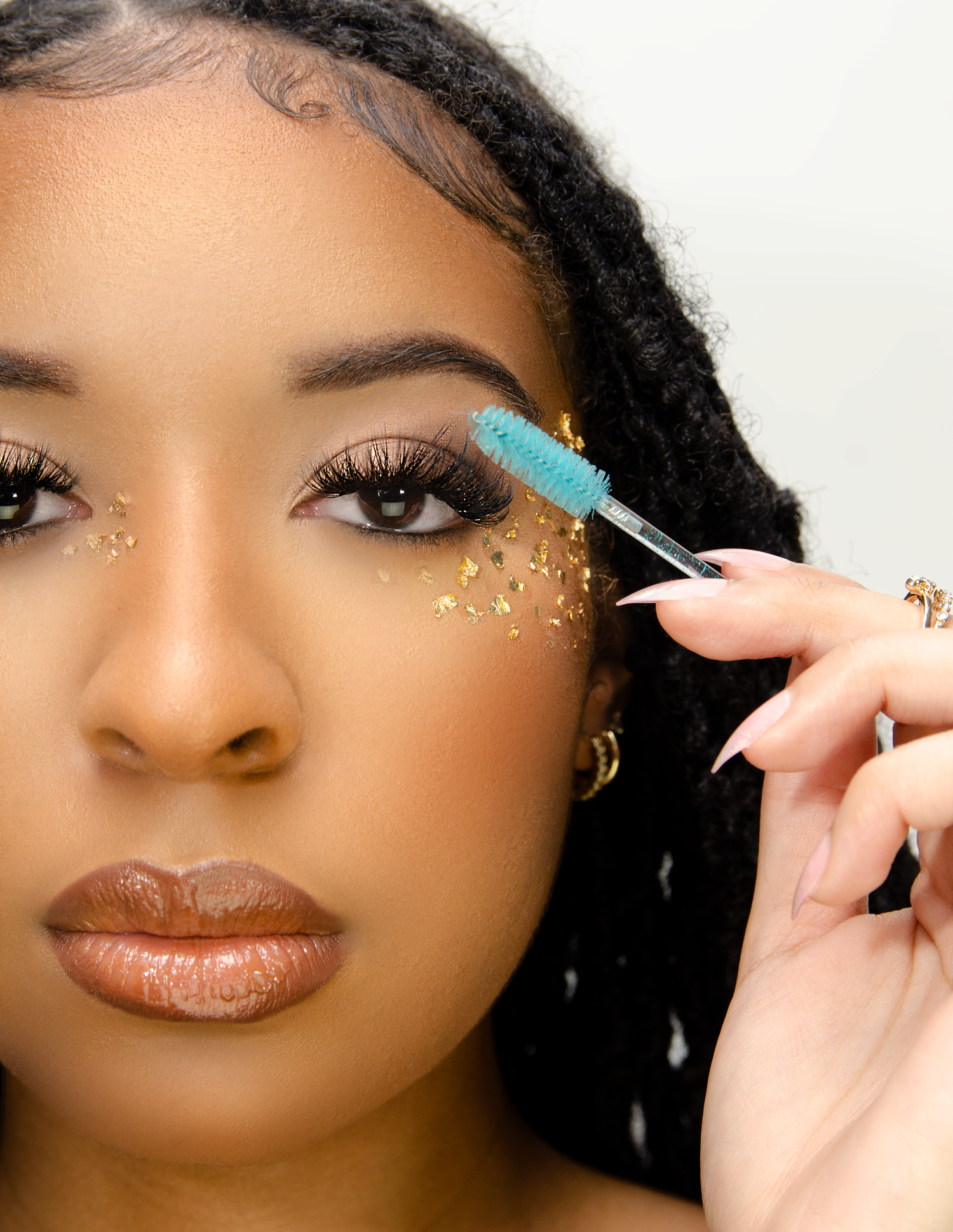 a girl brushing her eye lashes-editorial photoshoot.