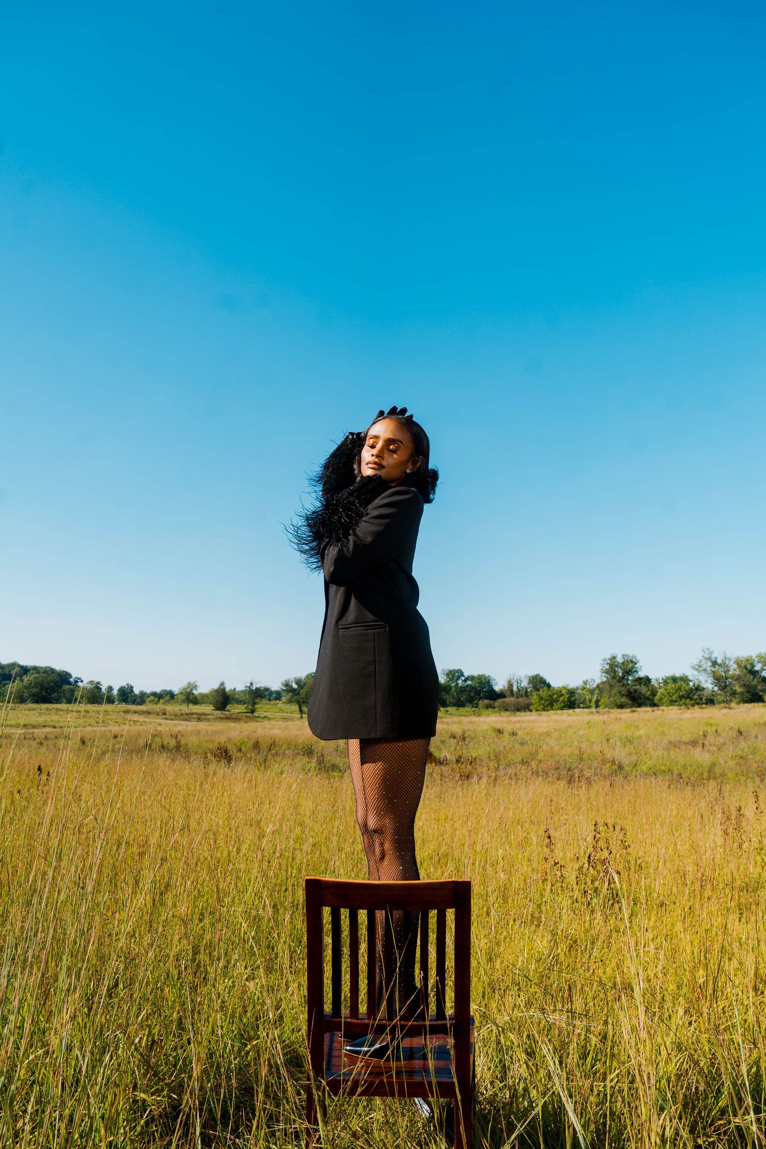 Girl in tall grass posing-editorial