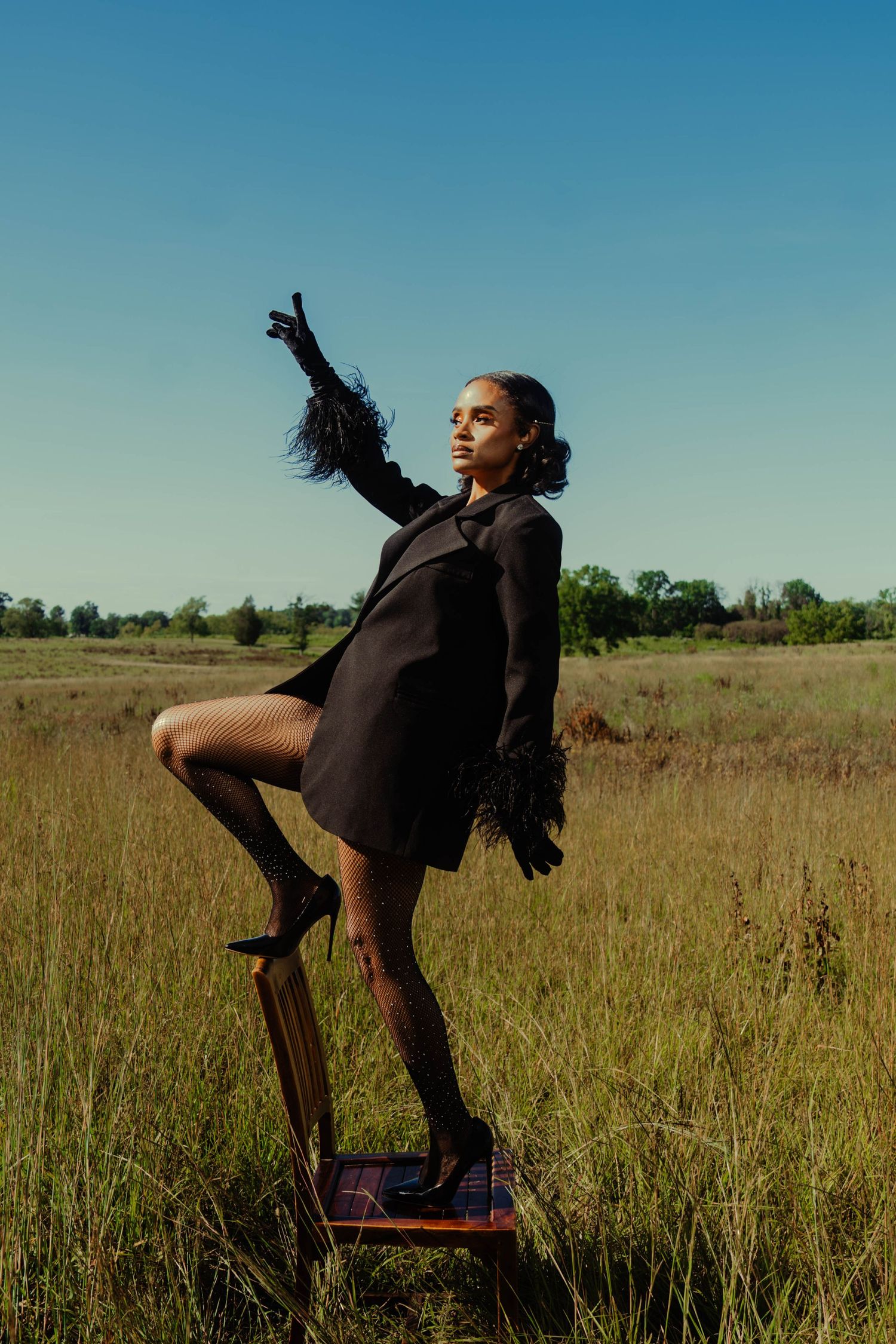 Girl in tall grass posing-editorial