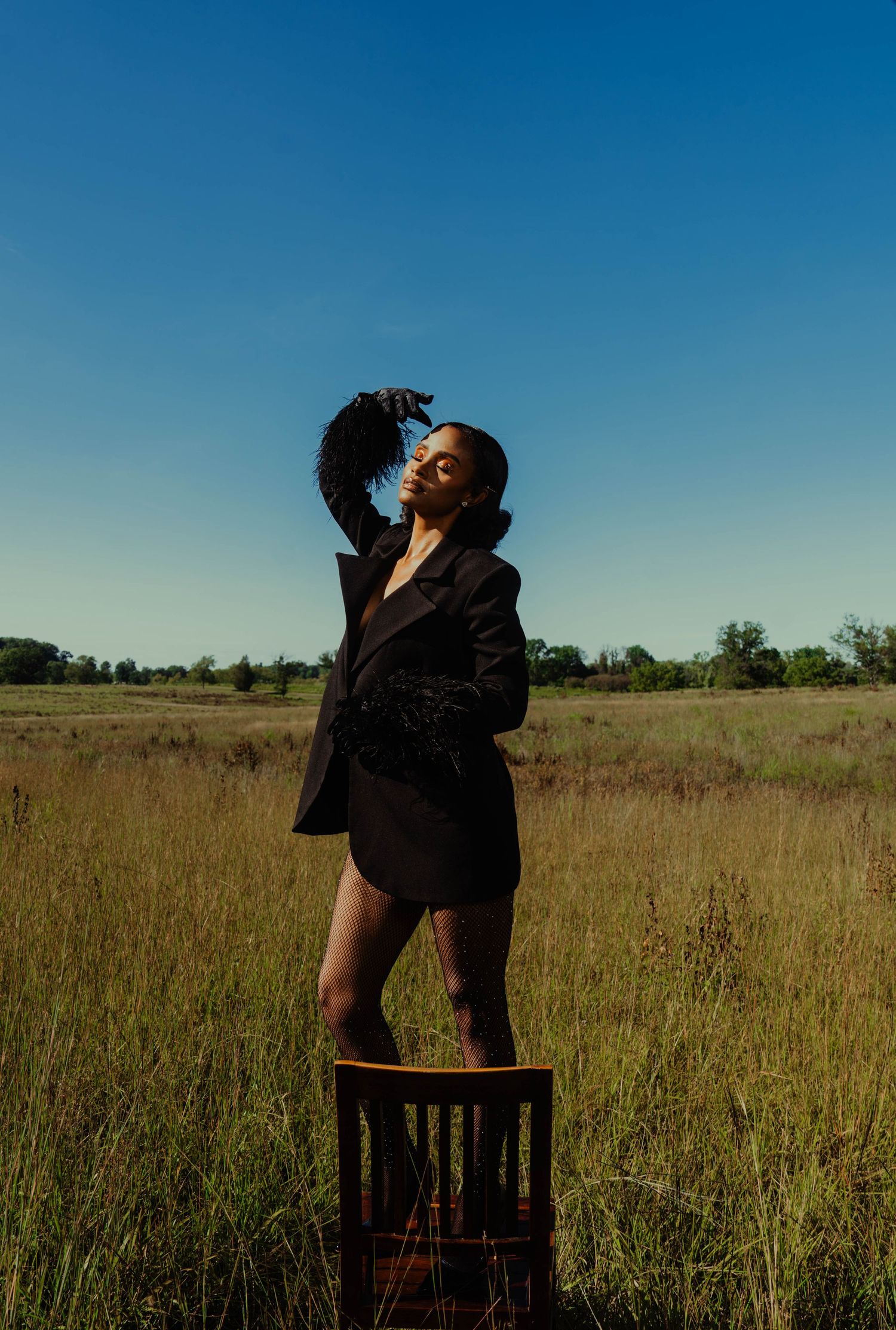 Girl in tall grass posing-editorial
