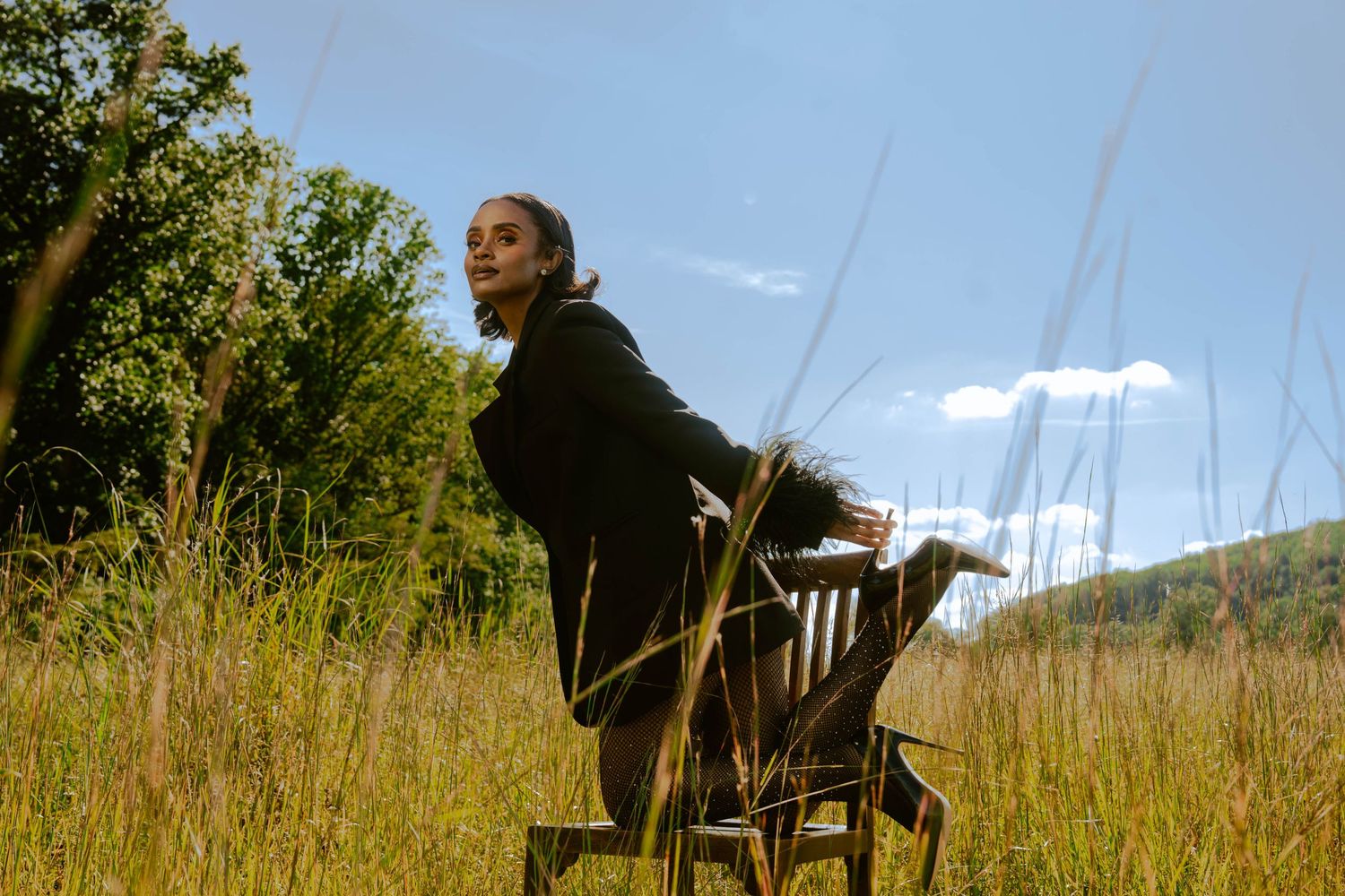 Girl in tall grass posing-editorial