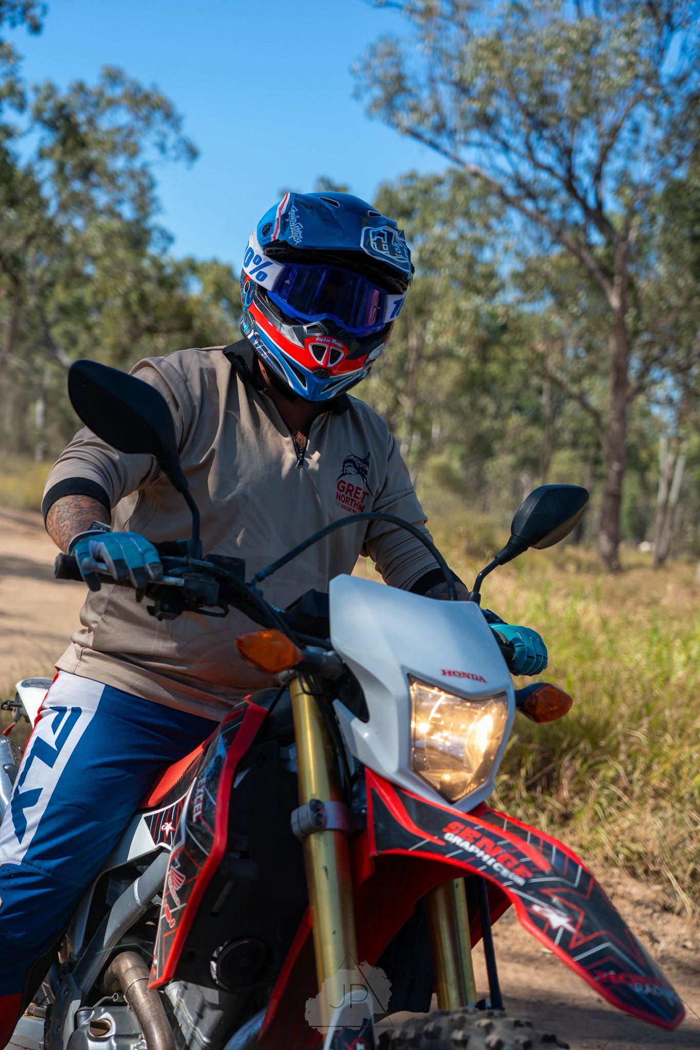 A sequence of four motocross action shots showing a rider on a red and white dirt bike maneuvering through rough terrain.