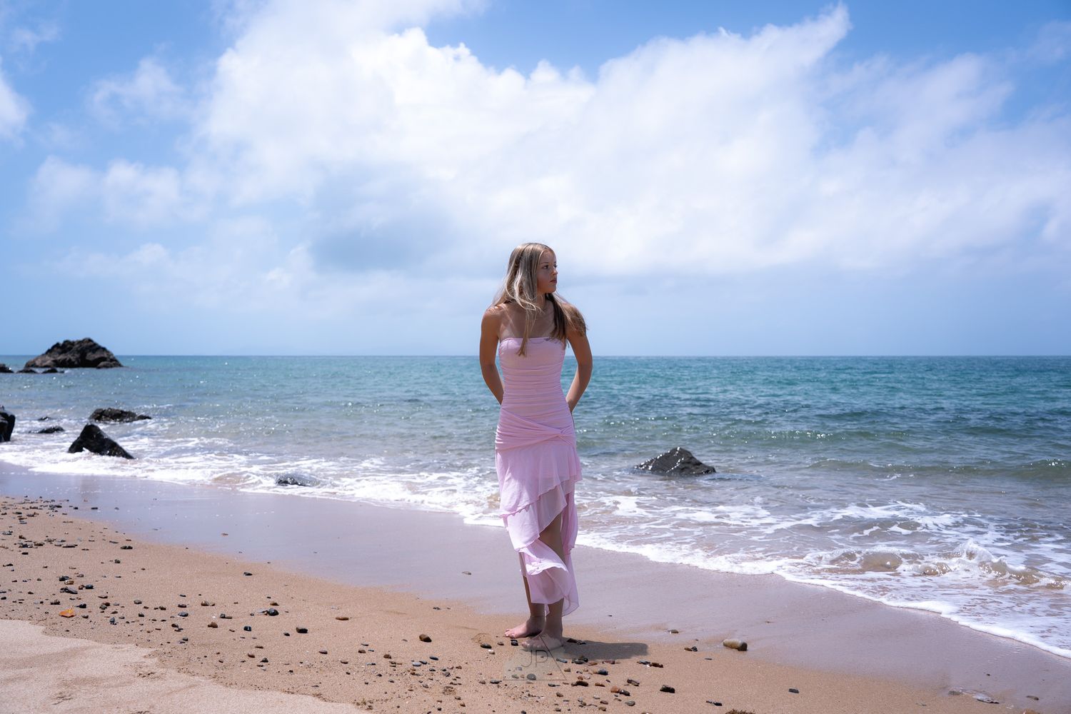 A series of beach scenes showing waves crashing on rocks and someone walking along the sandy shoreline.