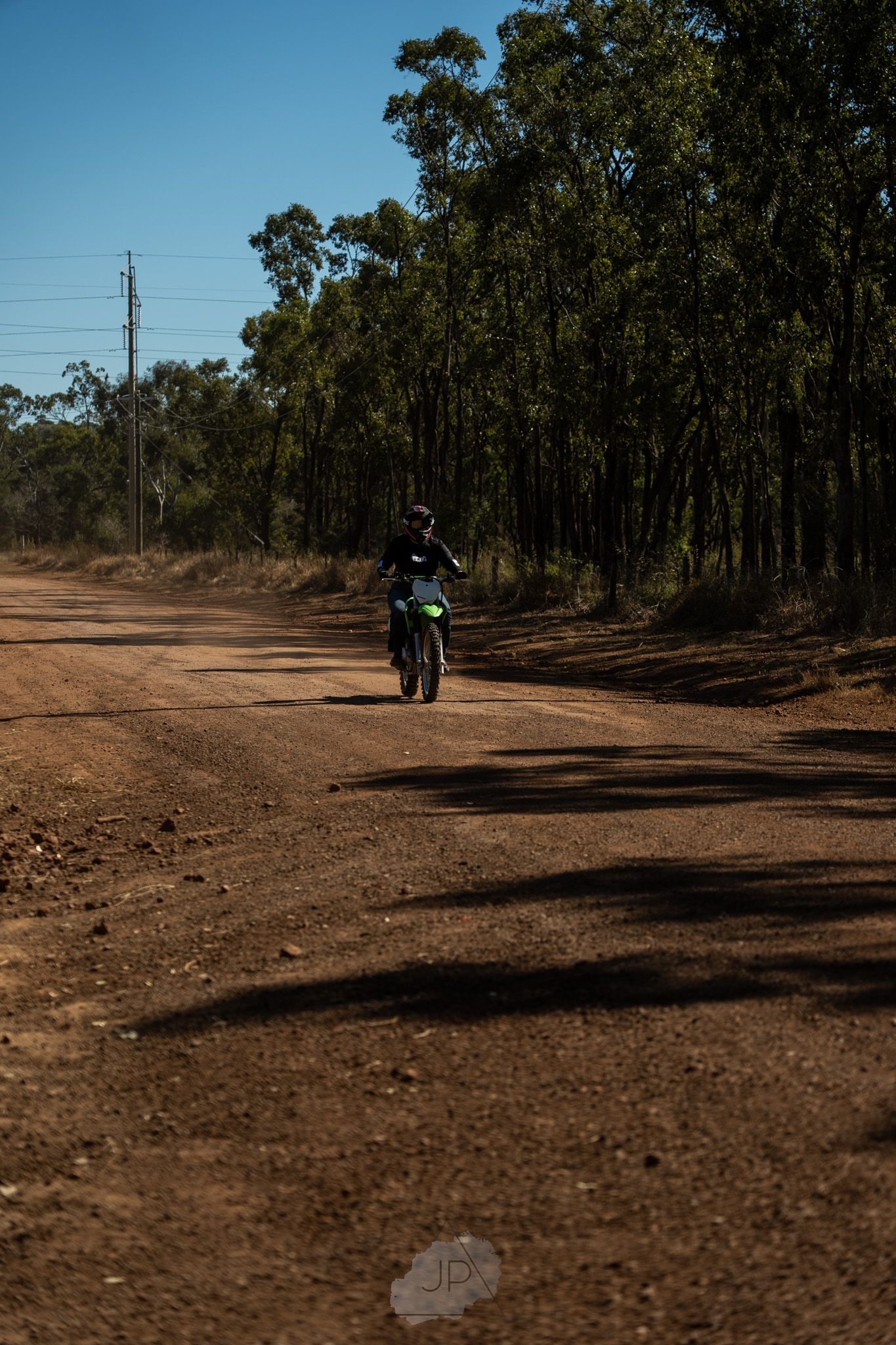 A series of sequential photos showing a dirt trail winding through a wooded gumtree forest.
