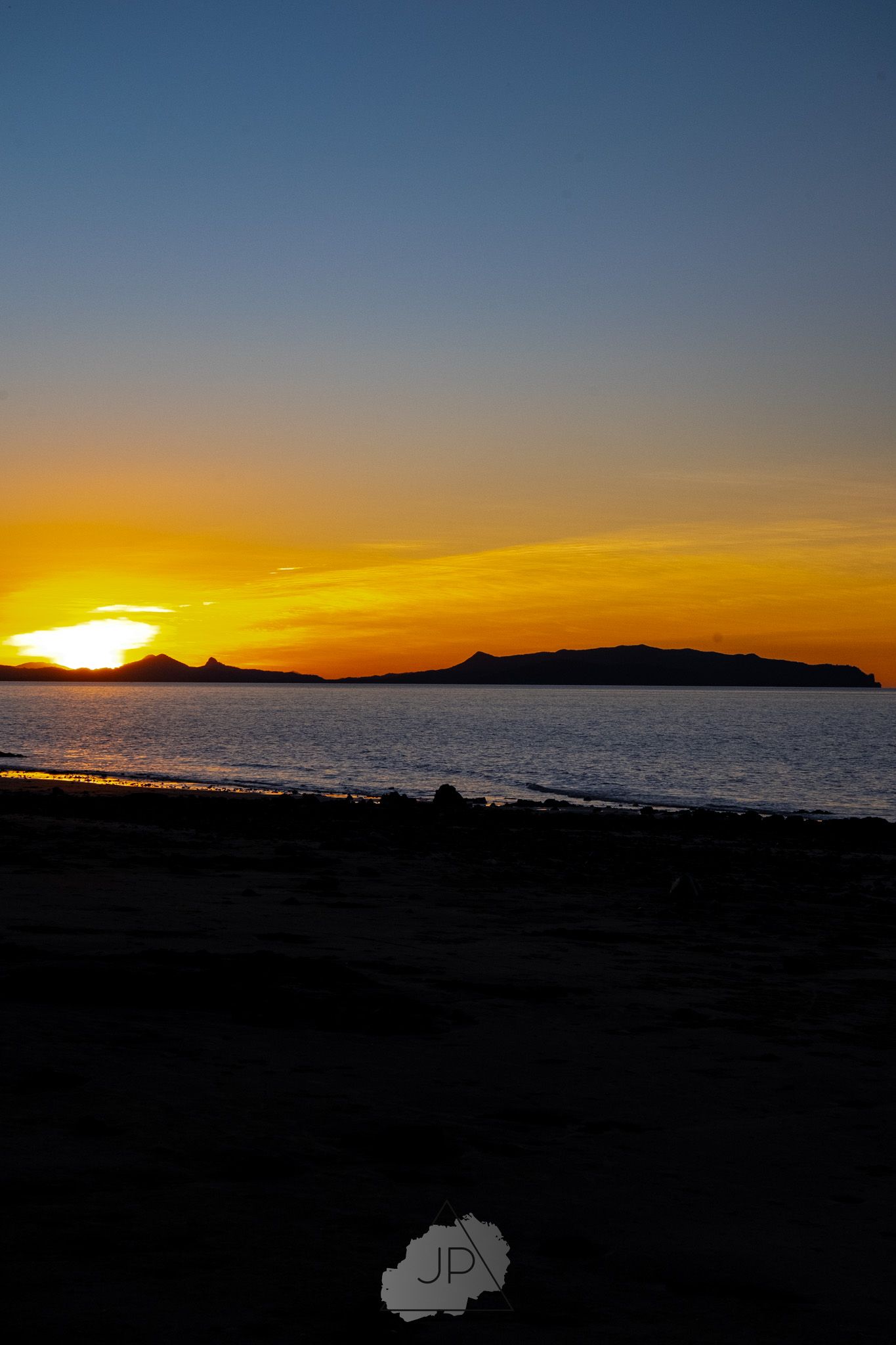 Series of photographs showing a vibrant sunset over the ocean, transitioning from deep blue to golden orange hues at horizon.