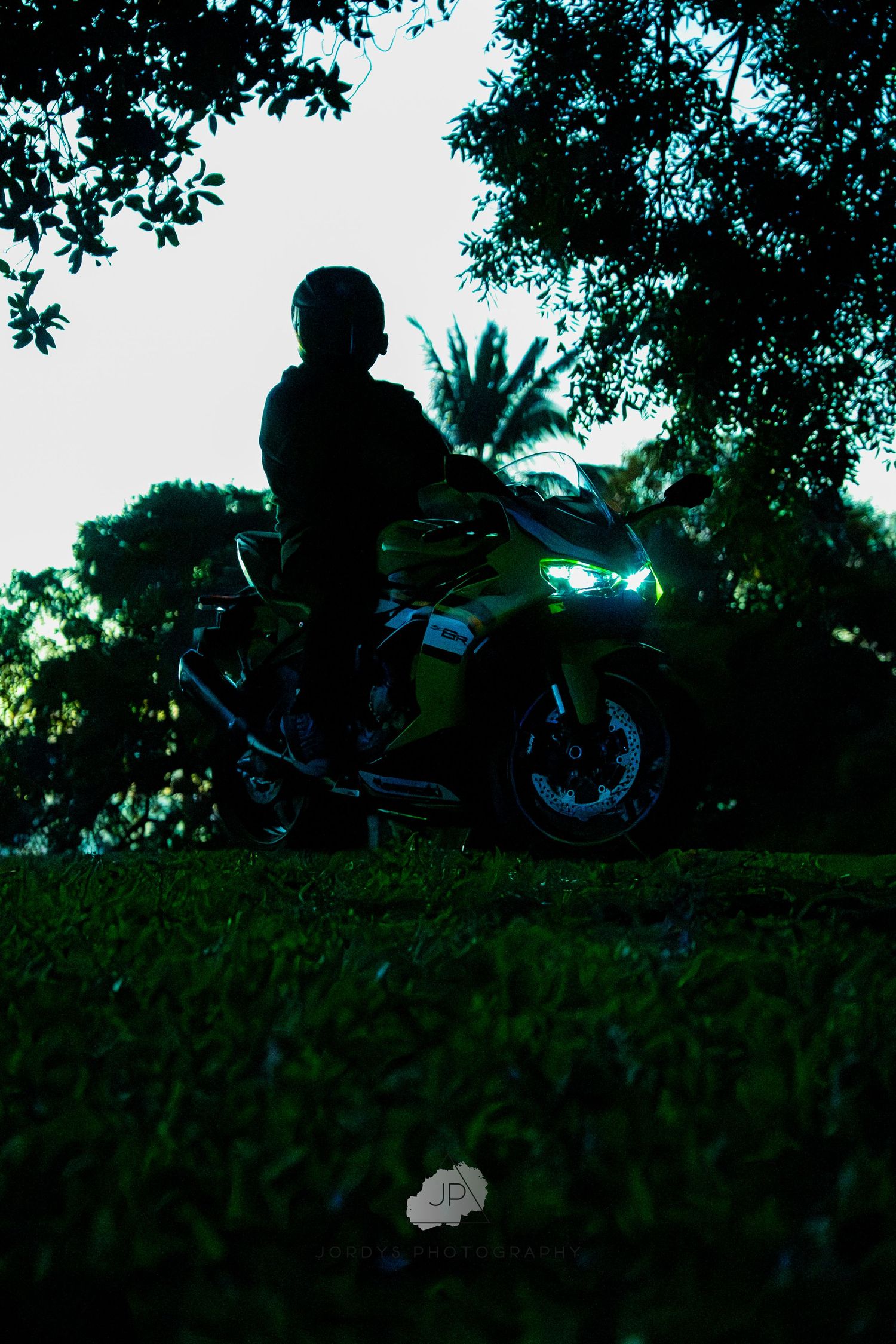 Dark silhouetted scene showing a motorcycle jumping sequence in five progressive frames of a dirt bike soaring through the air.
