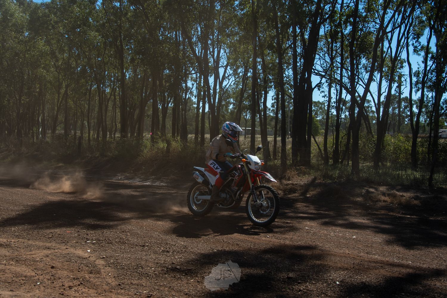 Multiple photos of dirt bike tracks winding through a wooded forest trail system with sunlight filtering through trees.
