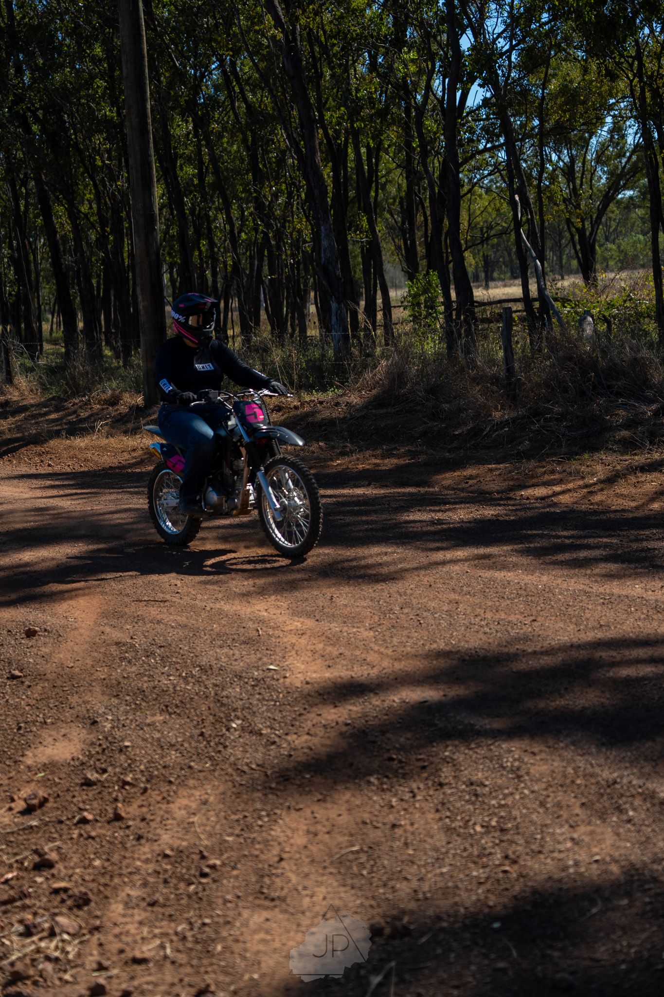 A series of photos showing a parked motorcycle in a wooded trail area surrounded by trees and fallen leaves.