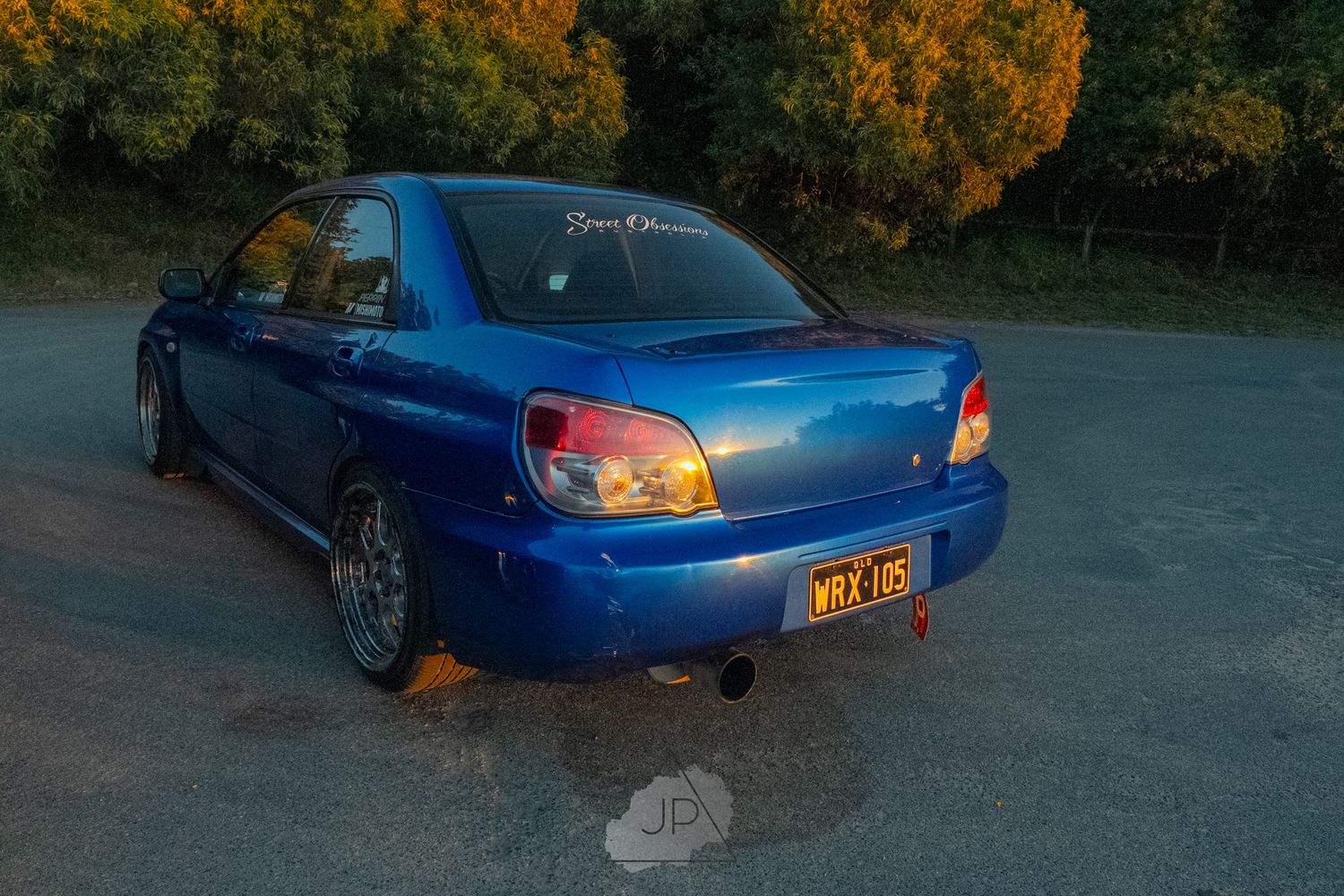 Blue Subaru WRX sports car shown from multiple angles parked in a lot during autumn.