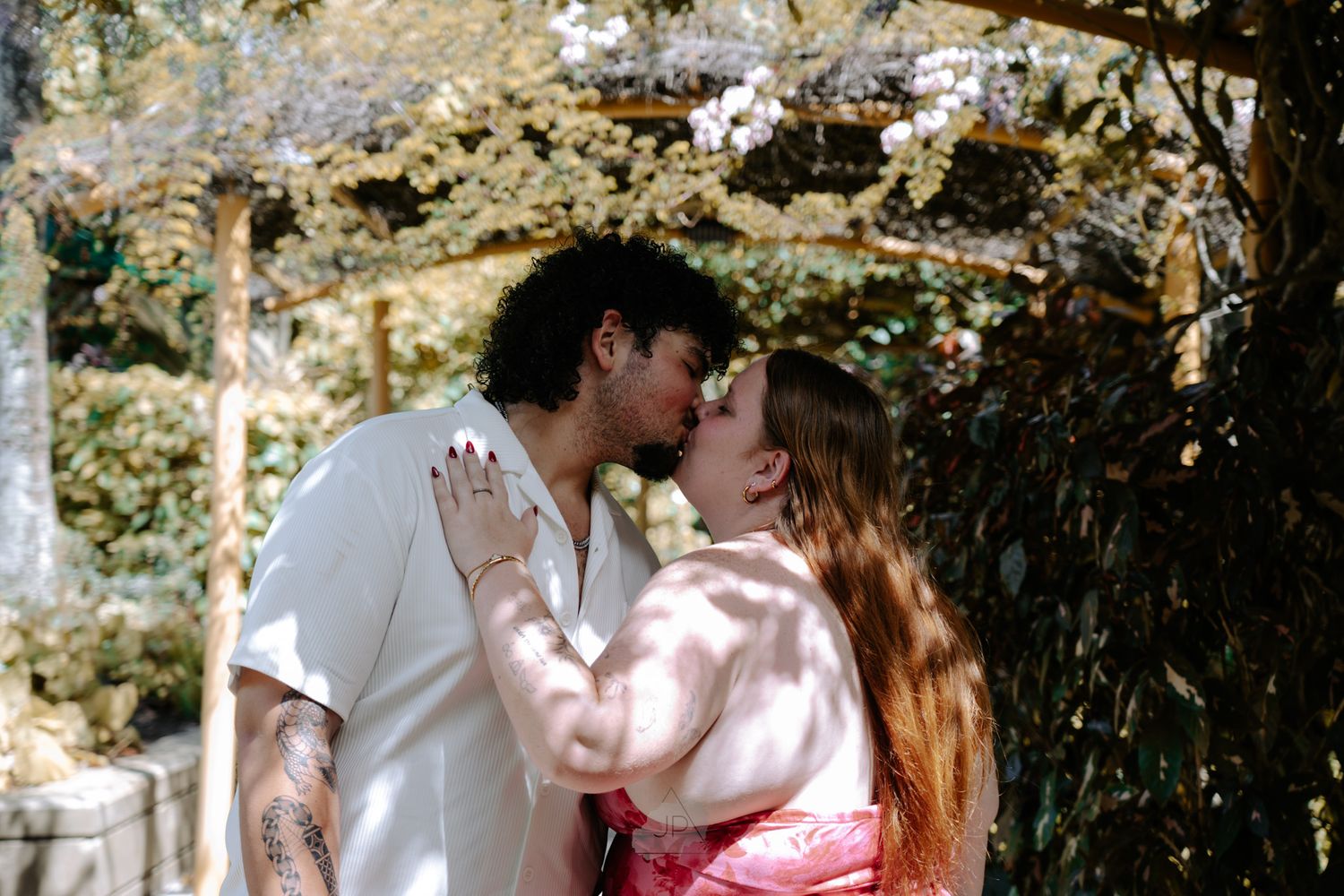 A couple shares romantic kisses in a sunlit garden setting across multiple photos.