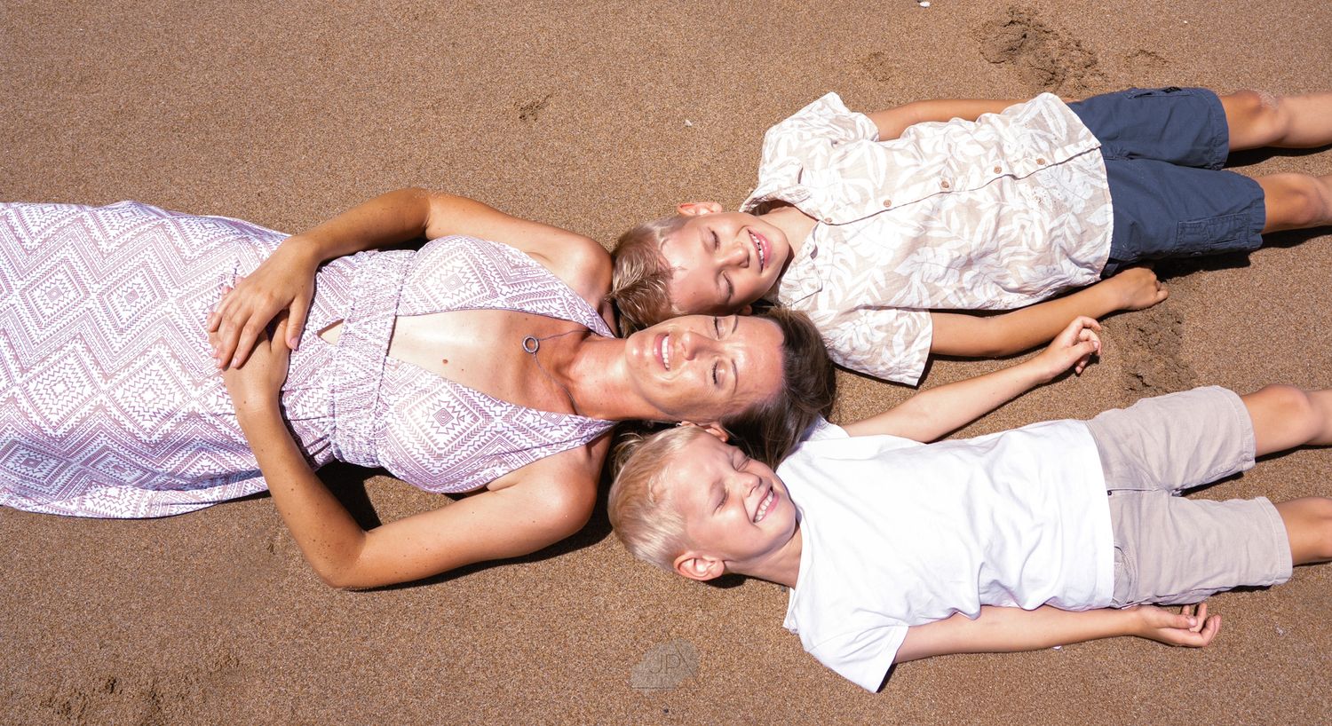 A sequence of photos showing a person lying on sand with papers scattered around them in different poses.