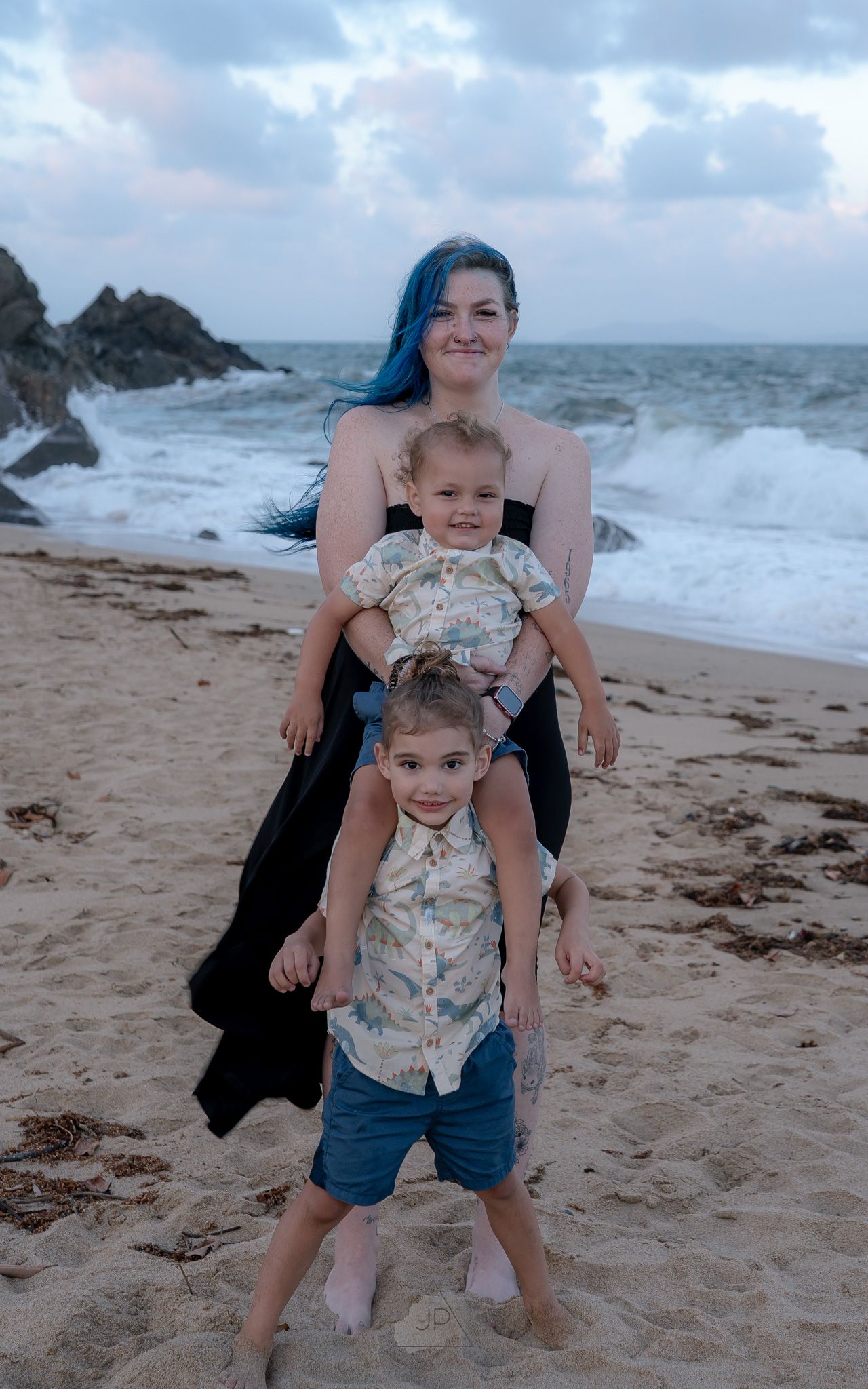 A sequence of playful moments at a beach with crashing waves and rocky coastline in the background.