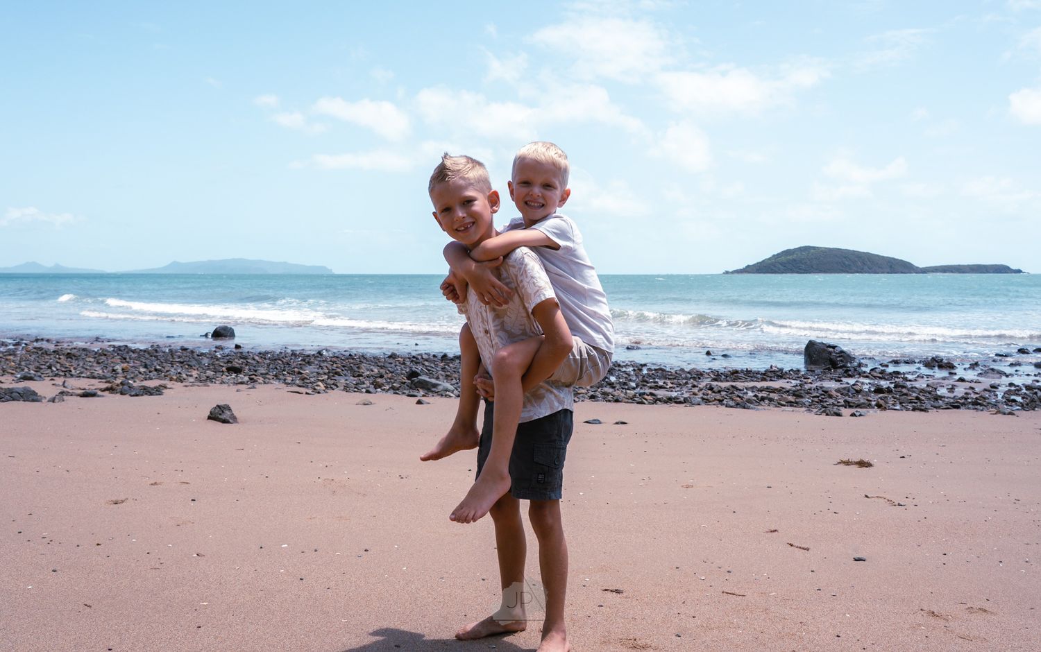 A sequence of photos showing someone enjoying a sunny day at a sandy beach with ocean waves in the background.