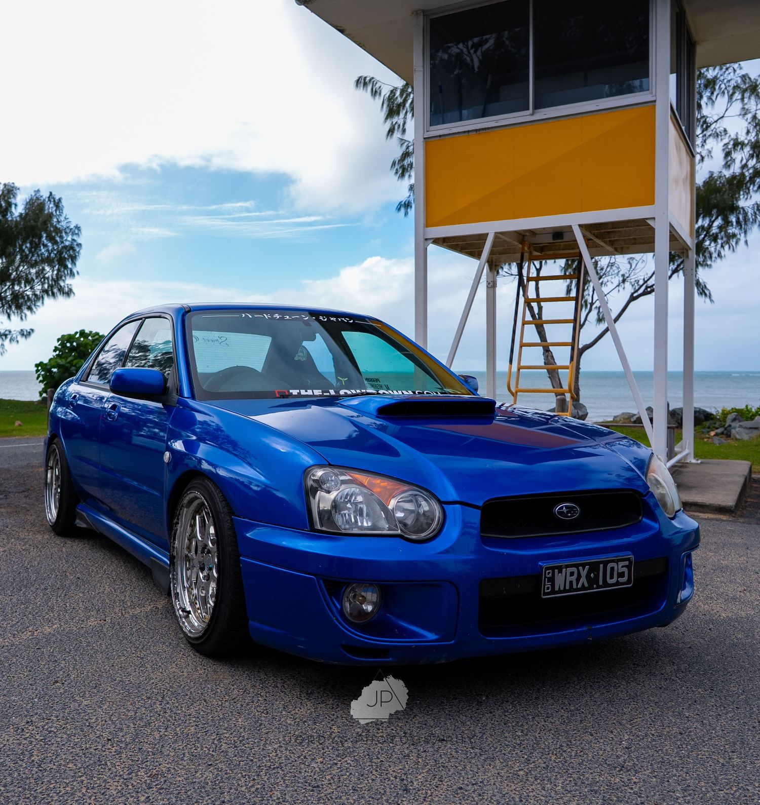 A blue Subaru WRX STI is captured from multiple angles showing off its sporty styling and iconic hood scoop.