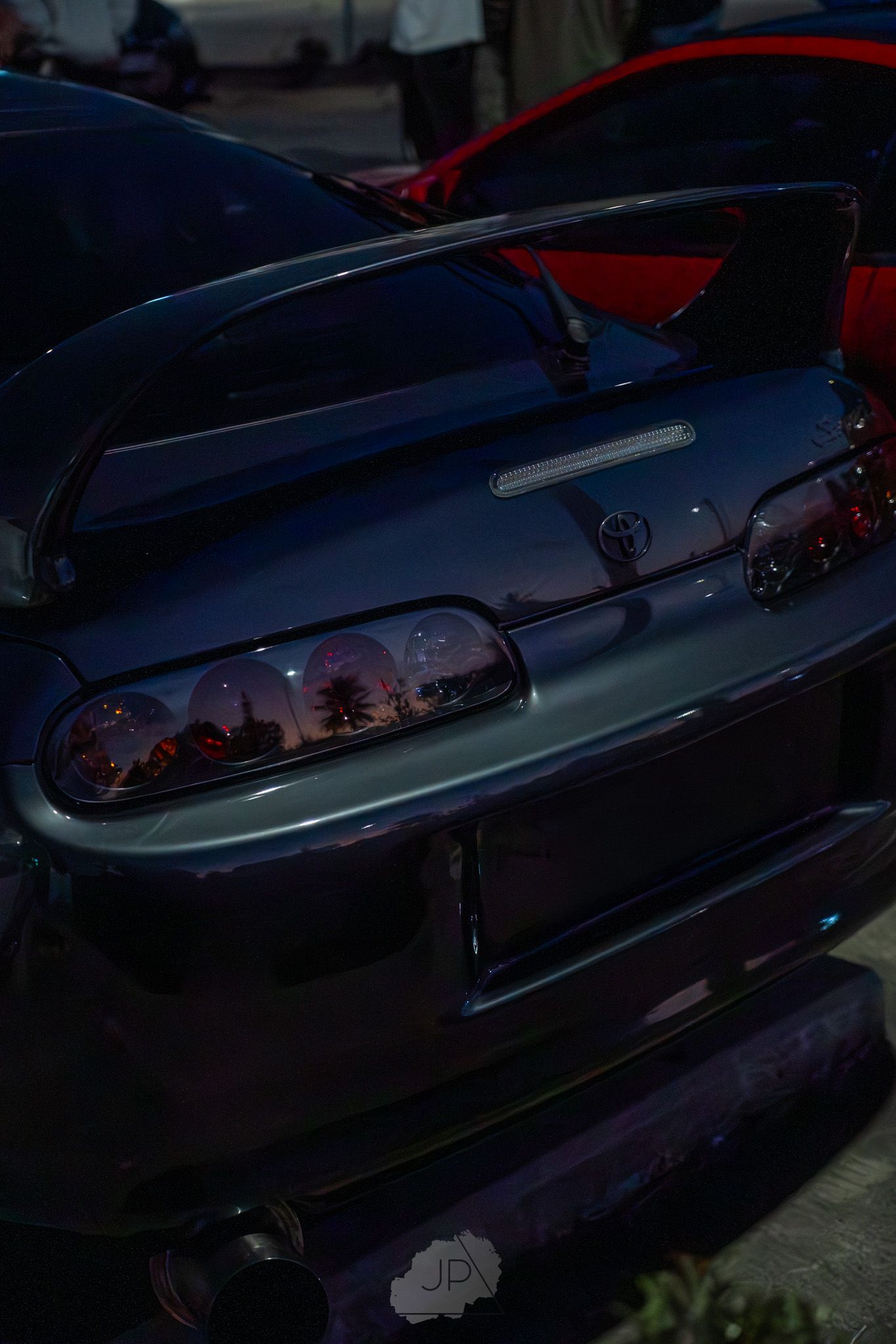 Close-up shots of a dark blue classic Chevrolet Impala lowrider car with custom details at dusk.