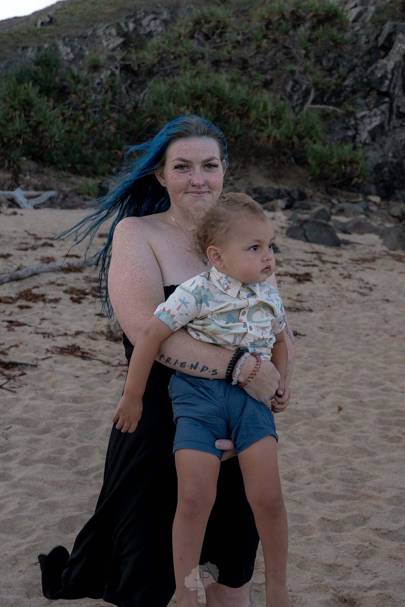 A series of beach photos showing playful moments on sandy shores with rocky cliffs in the background.