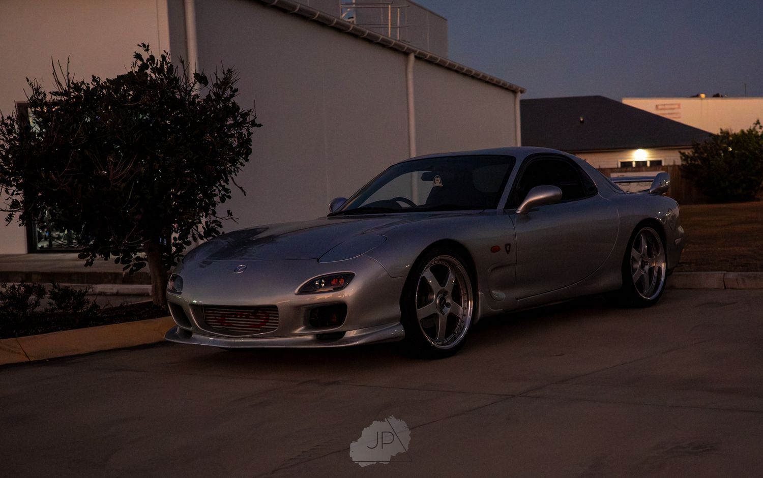 A silver sports car is parked on a street at sunset with multiple angles shown in a collage.
