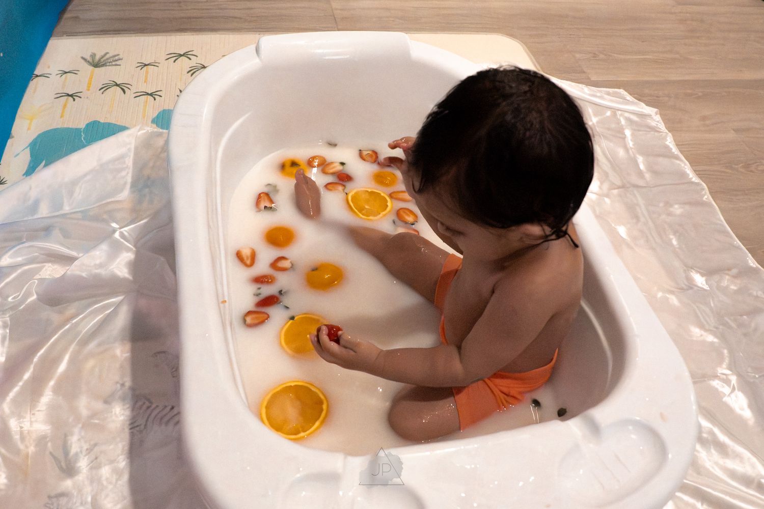 Raw eggs being cracked onto a plastic-covered surface in a sequence of preparation steps.