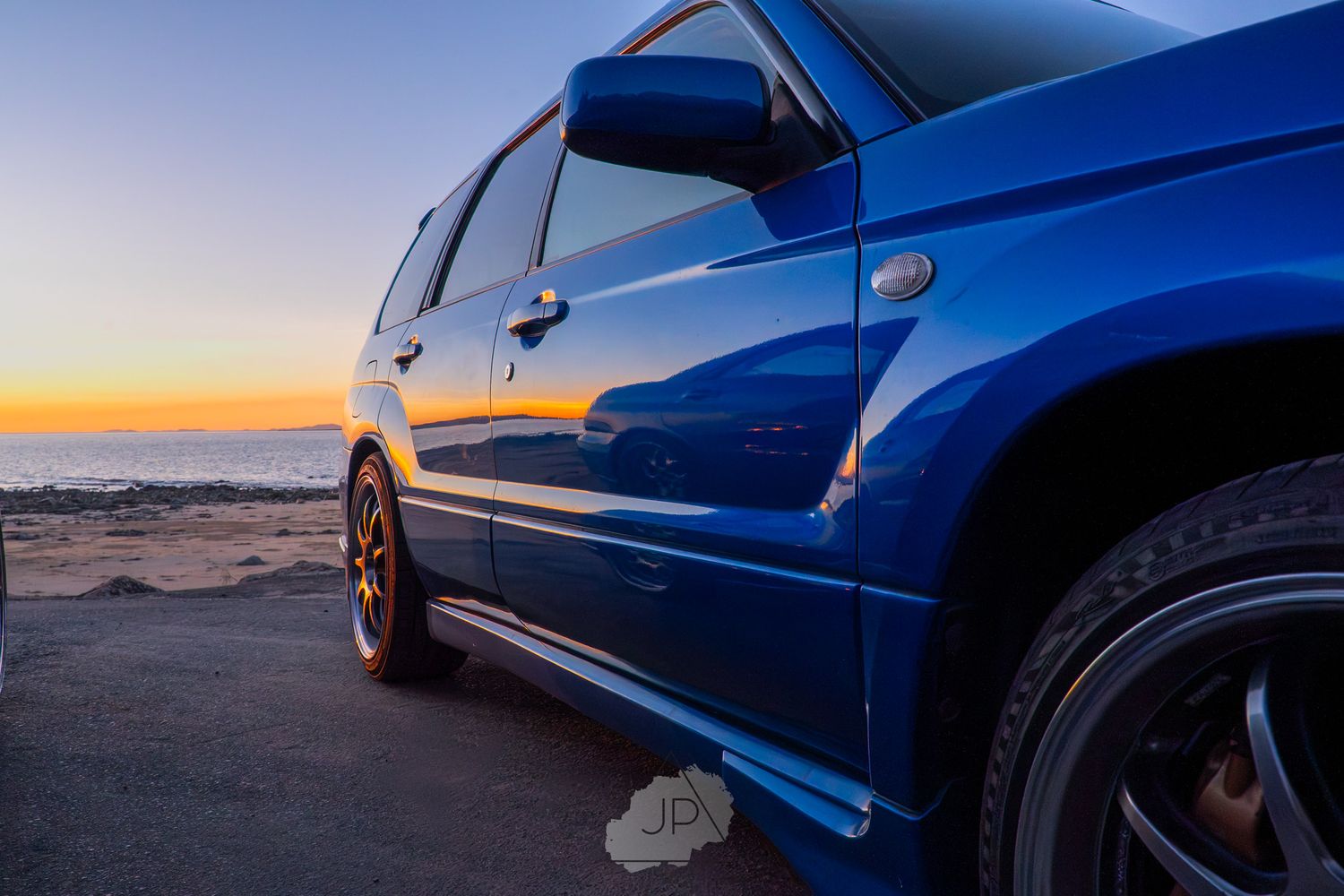 Blue Subaru WRX photographed at sunset against desert landscape showing different exterior angles.