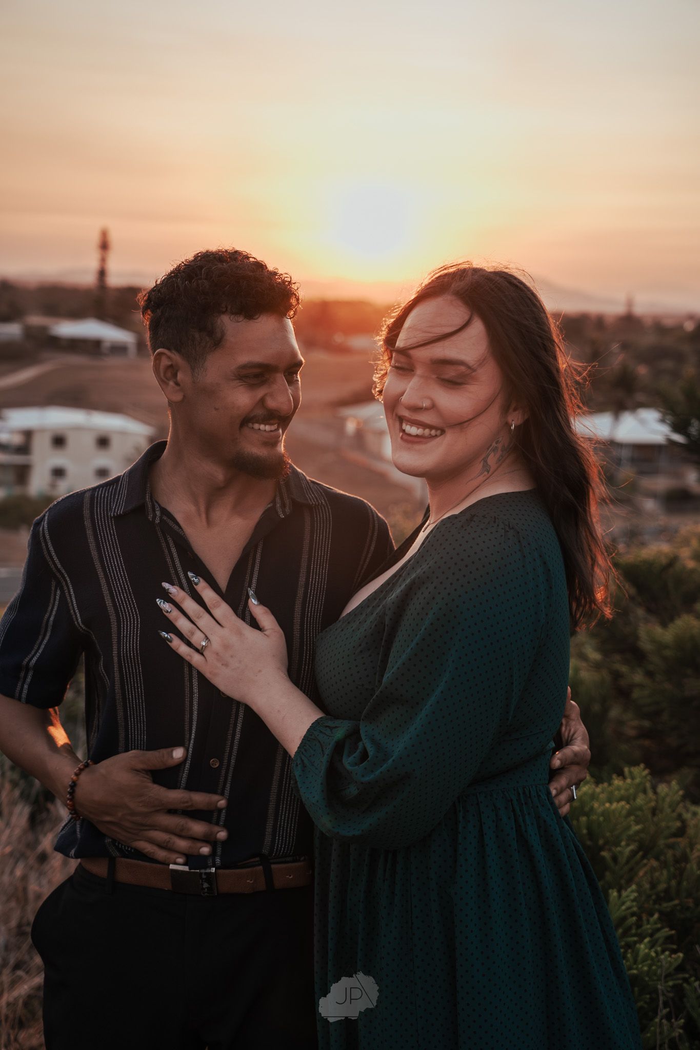 Romantic sunset engagement session showing couple's natural chemistry and laughter.