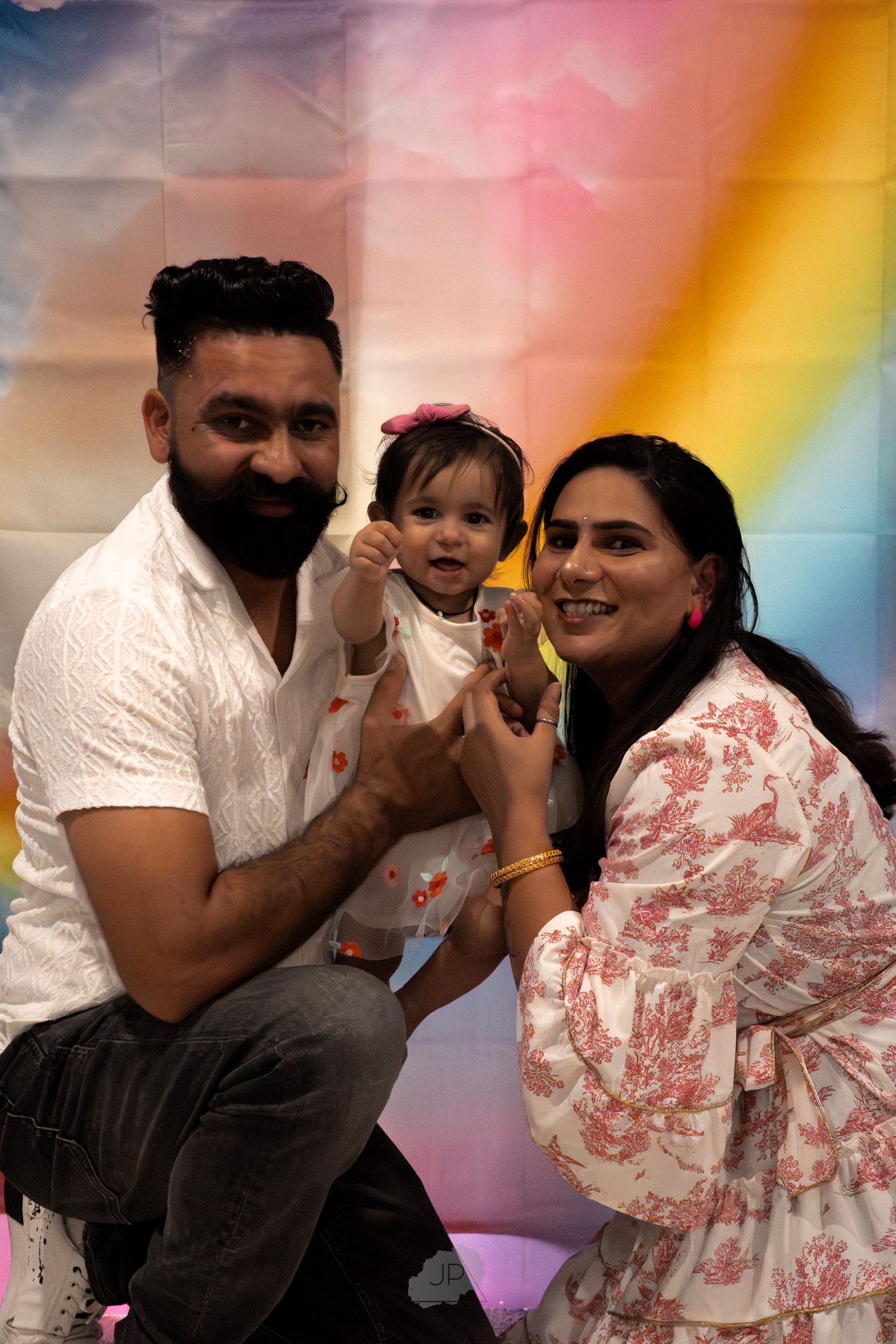 A sequence of candid photo booth style images showing joyful moments with colorful rainbow lighting effects in the background.
