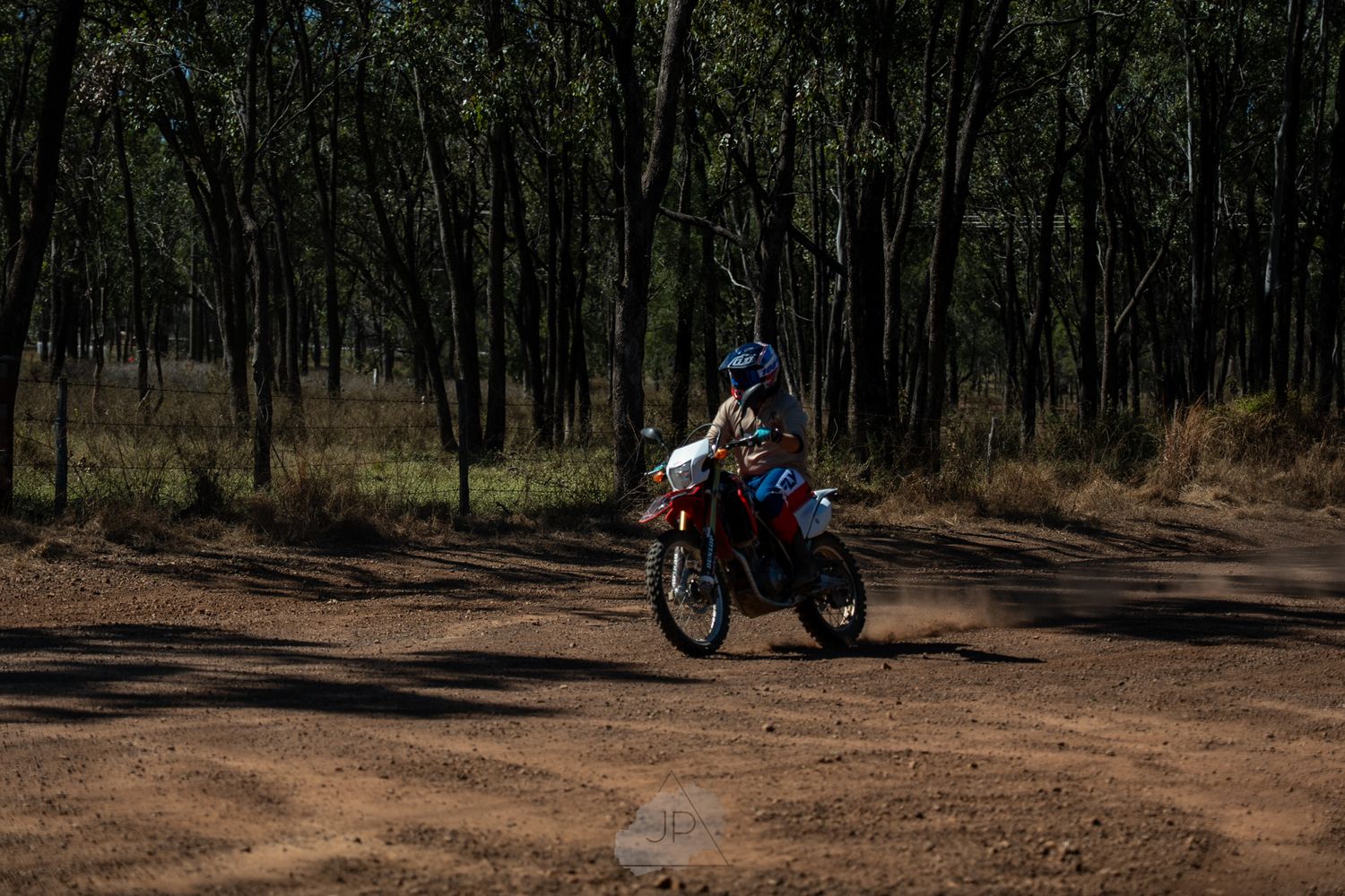 A sequence of motorcycle riding shots on a forest dirt trail.