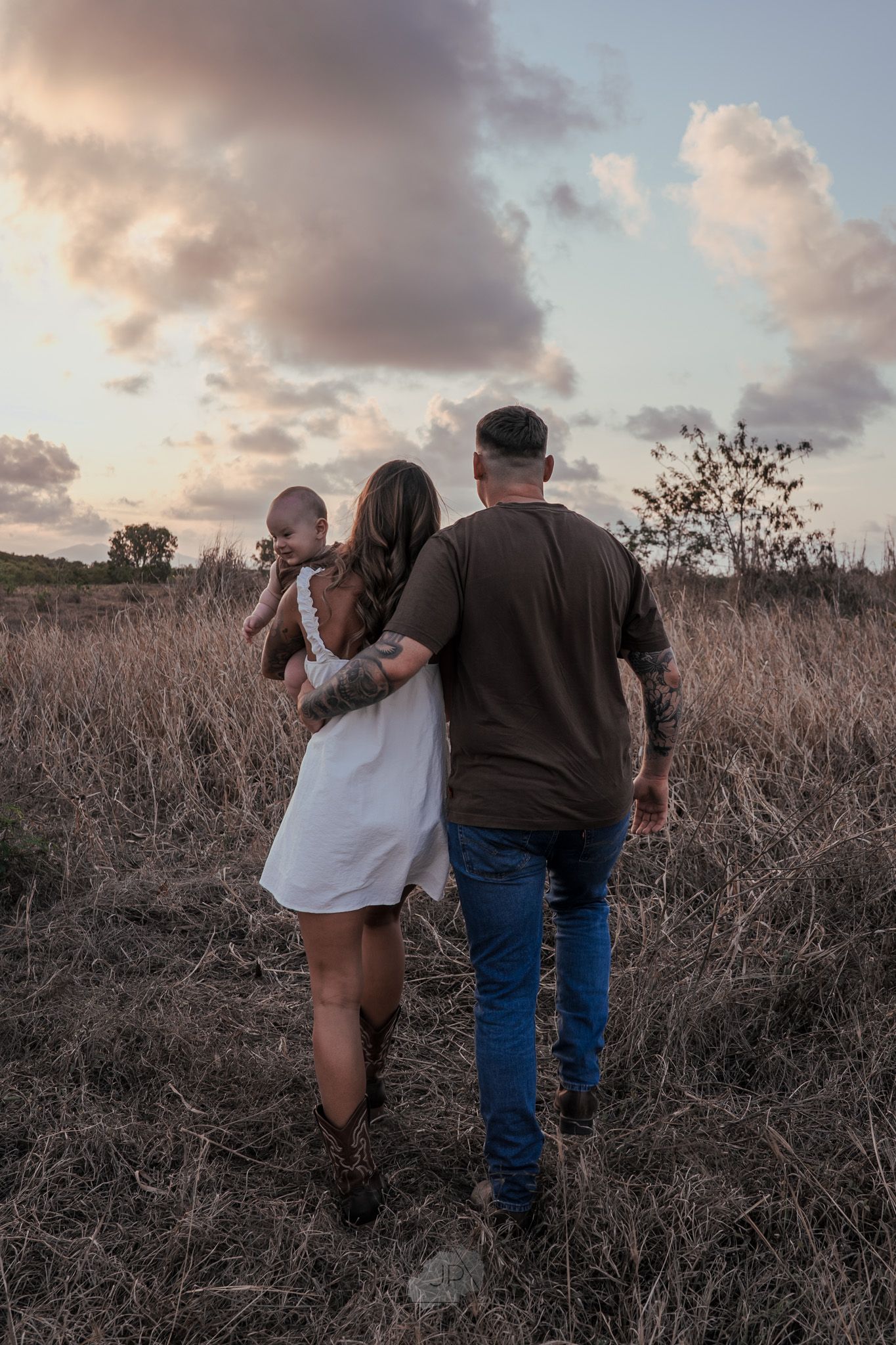 Couple in rustic field at sunset share intimate moments across four sequential photos.
