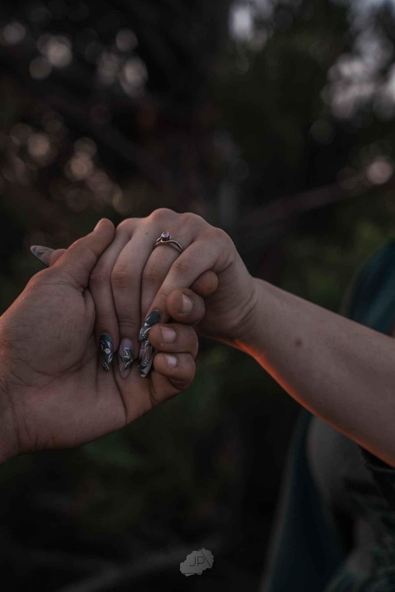 Four cropped photos showing two hands making a pinky promise gesture against a dark blurred background.