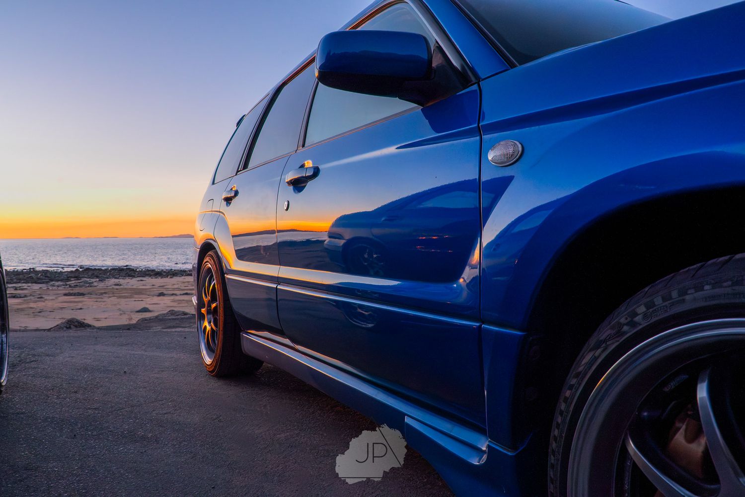 A montage of blue Subaru WRX STI sports cars photographed at various angles during sunset.