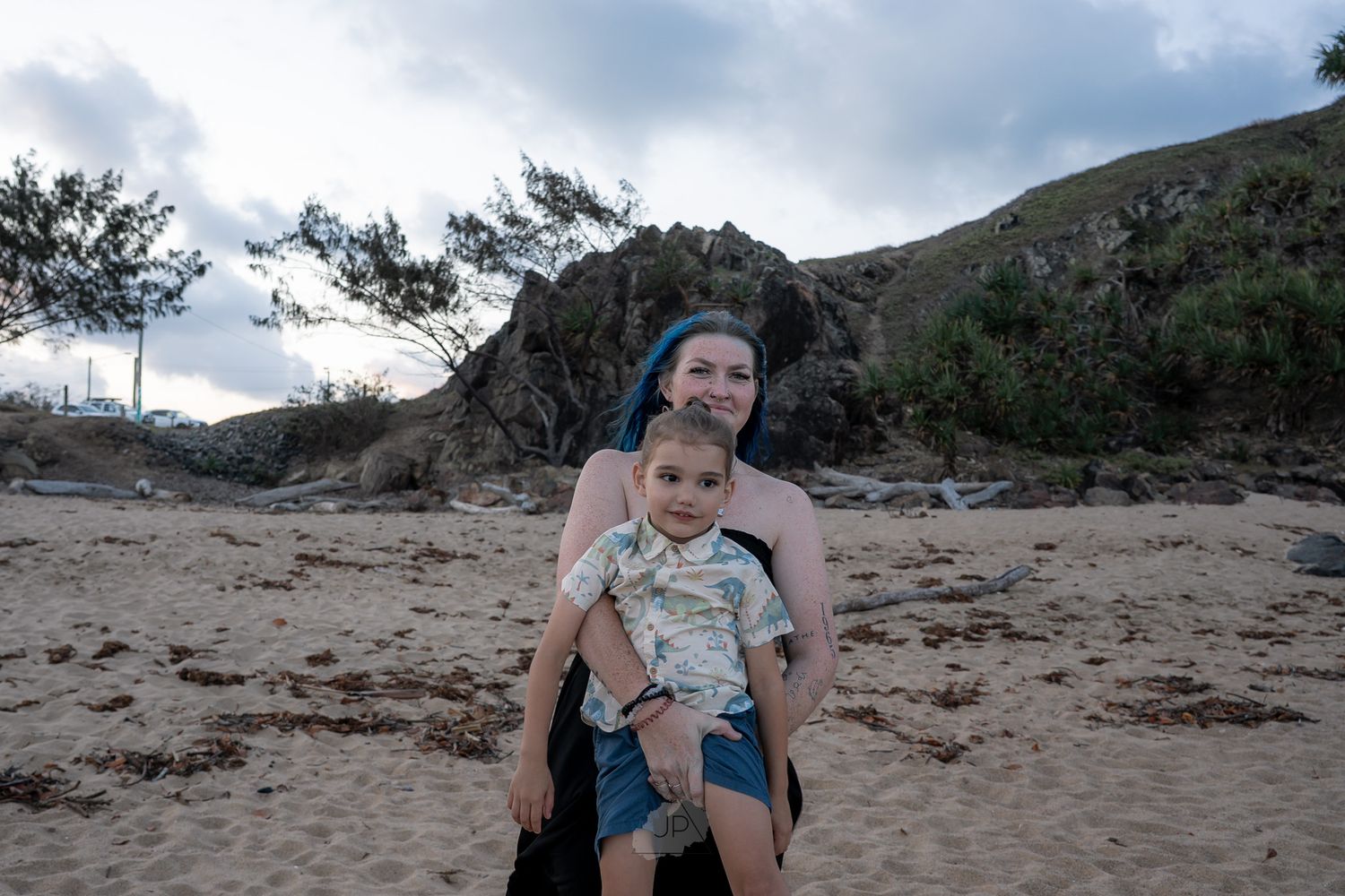 A series of photos showing a baby exploring a sandy beach area with an adult companion at sunset.