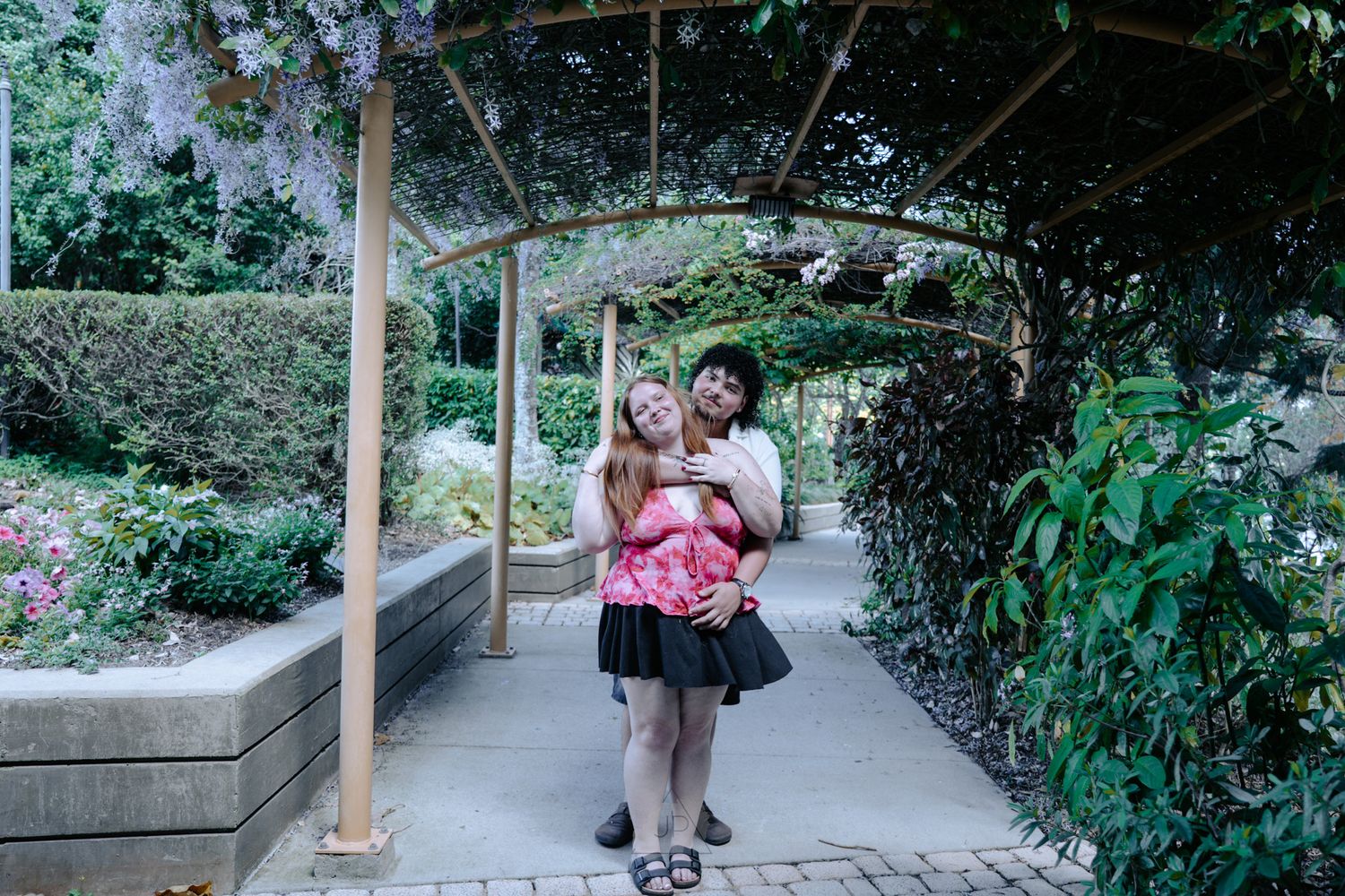 A series of walkway photos showing concrete paths winding through lush garden landscapes with wooden railings and greenery.
