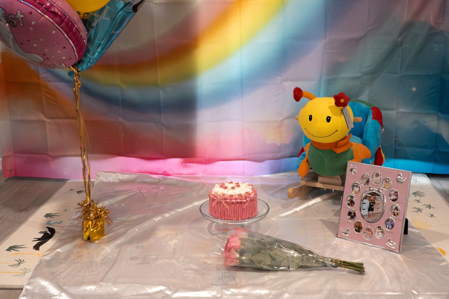 A collection of colorful party decorations and supplies arranged on a table with balloons and festive items.