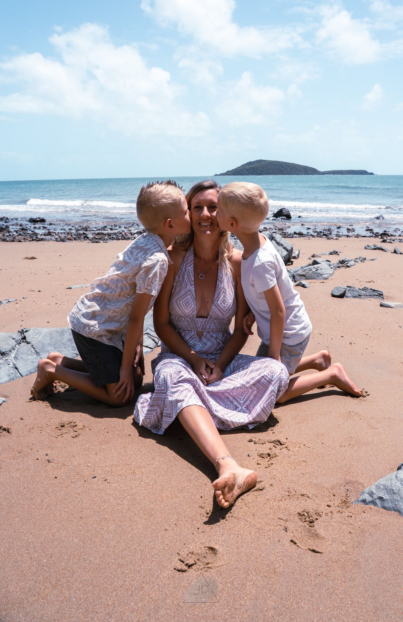A series of four photos showing people relaxing on a sandy beach with rocks and ocean views in the background.