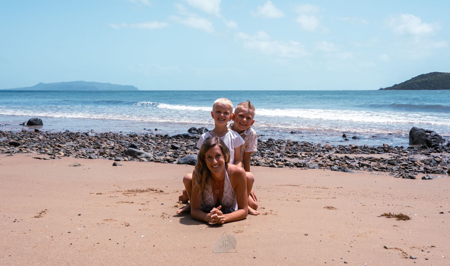 A sequence of beach photos showing someone relaxing on golden sand with waves and rocky coastline in the background.